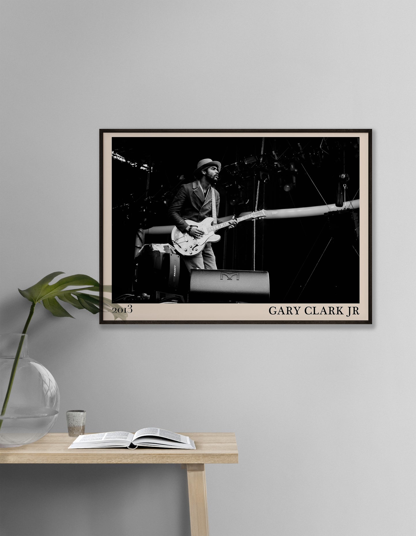 2013 photo of Gary Clark Jr crafted into an elegant black-framed print. Hanging on a white living room wall