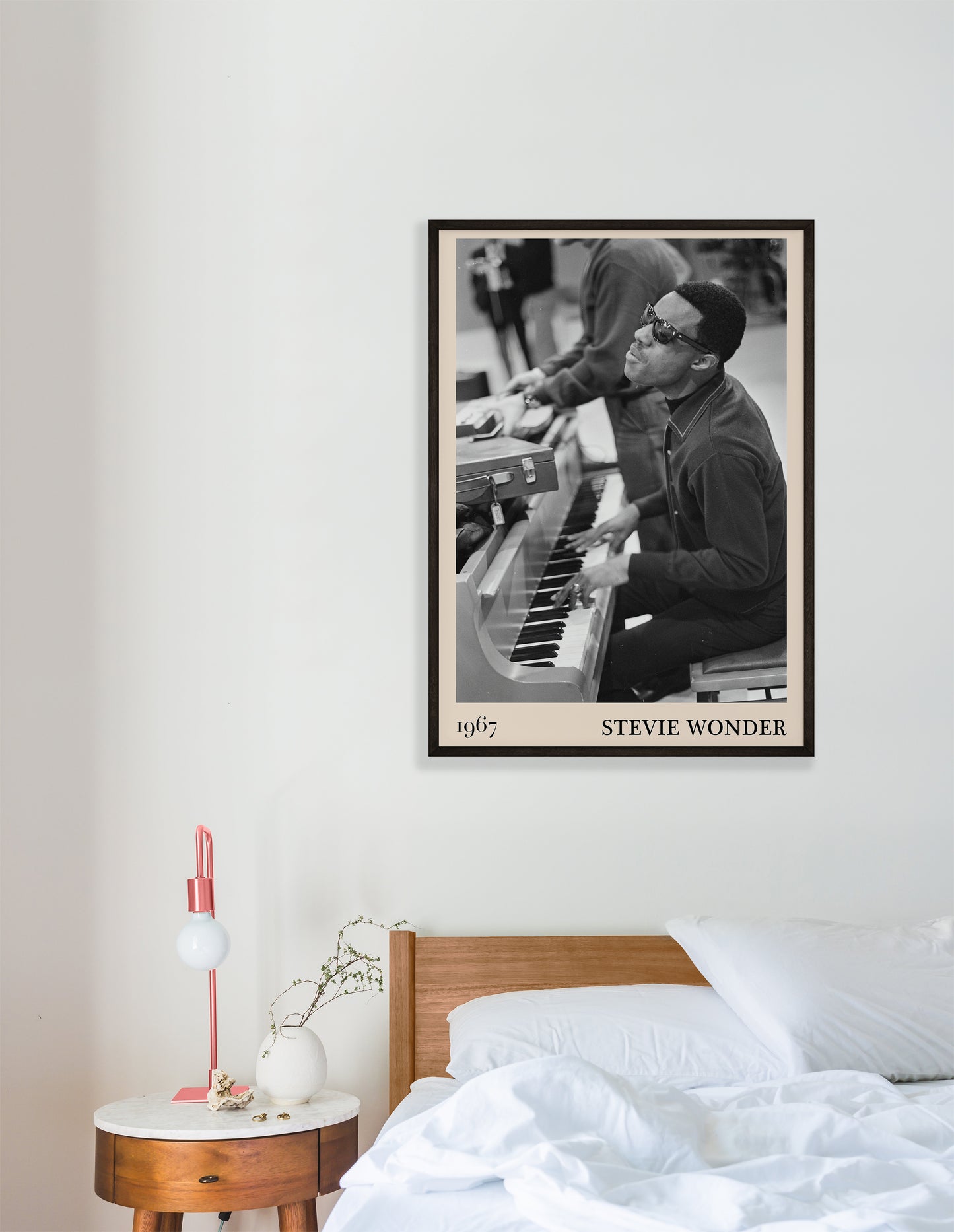 1967 photo of Stevie Wonder, crafted into an elegant black-framed print. Hanging on a white bedroom wall