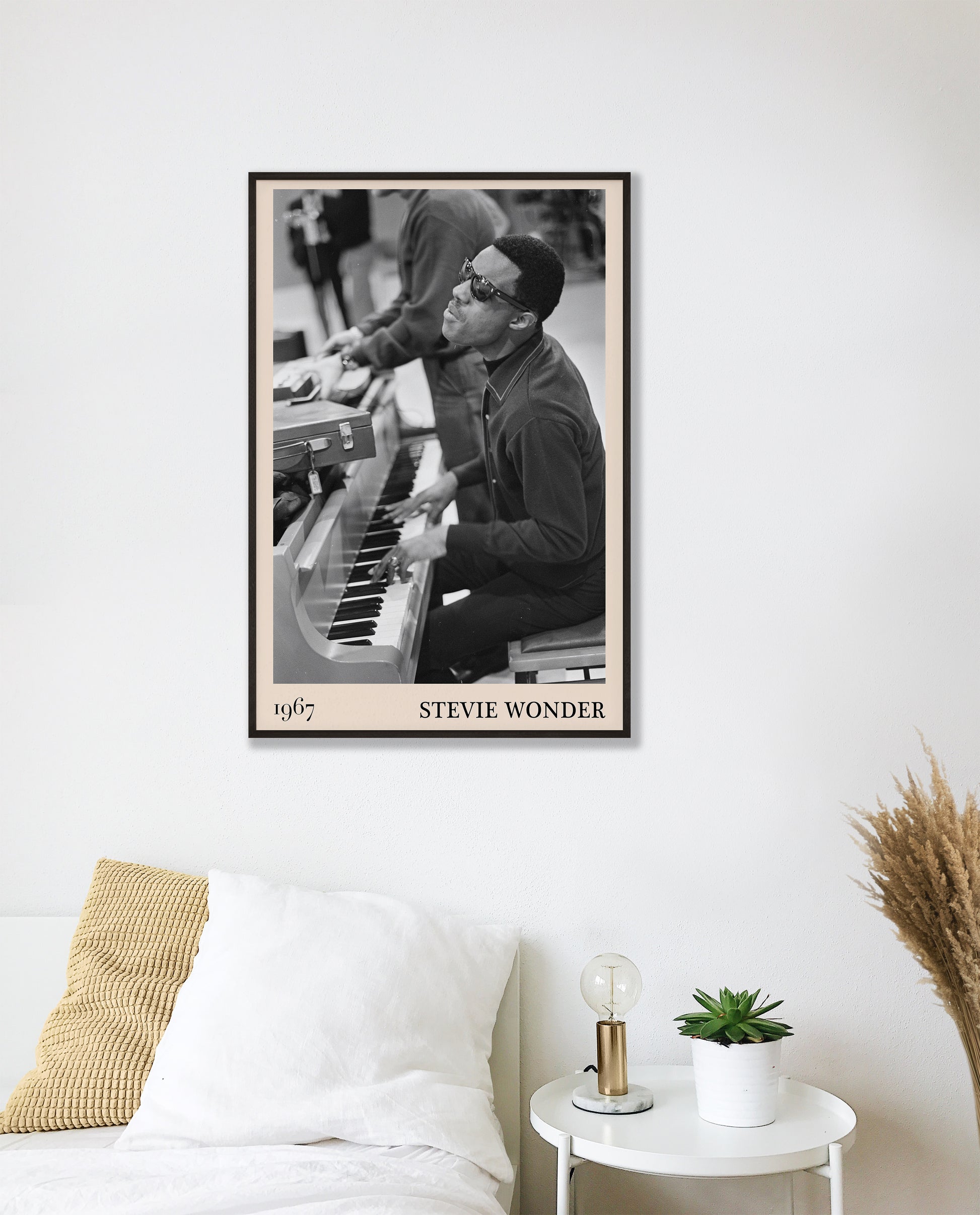 1967 photo of Stevie Wonder, crafted into an elegant black-framed print. Hanging on a white bedroom wall