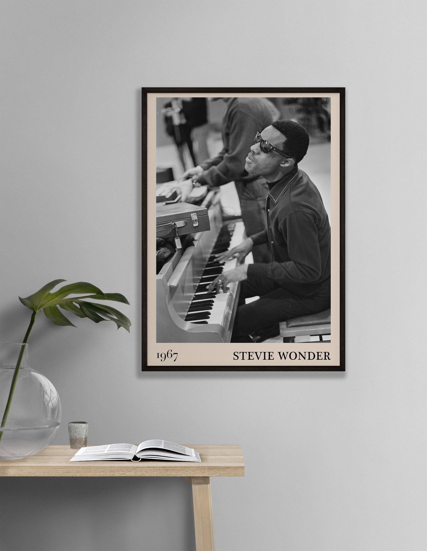1967 photo of Stevie Wonder, crafted into an elegant black-framed print. Hanging on a white living room wall