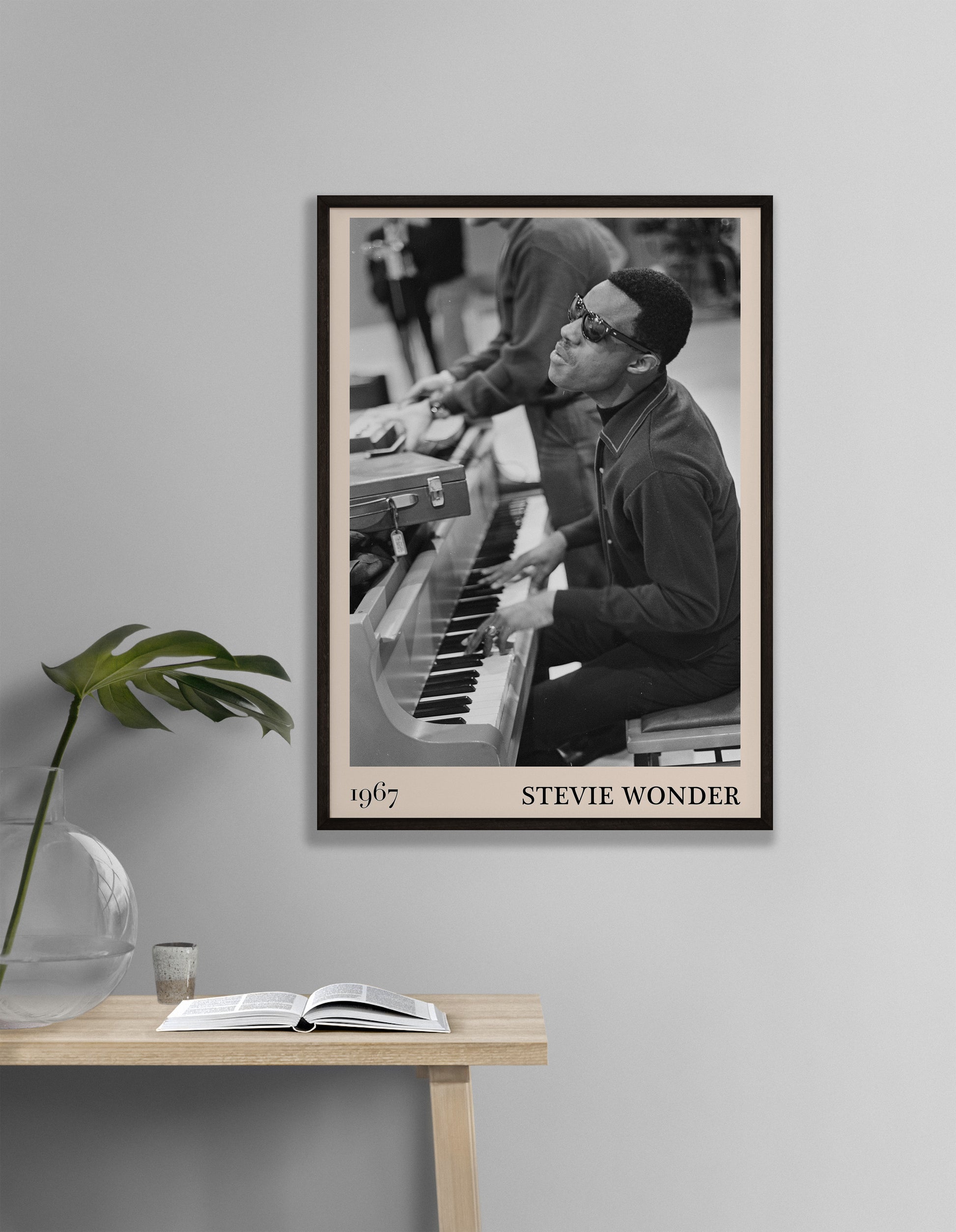 1967 photo of Stevie Wonder, crafted into an elegant black-framed print. Hanging on a white living room wall