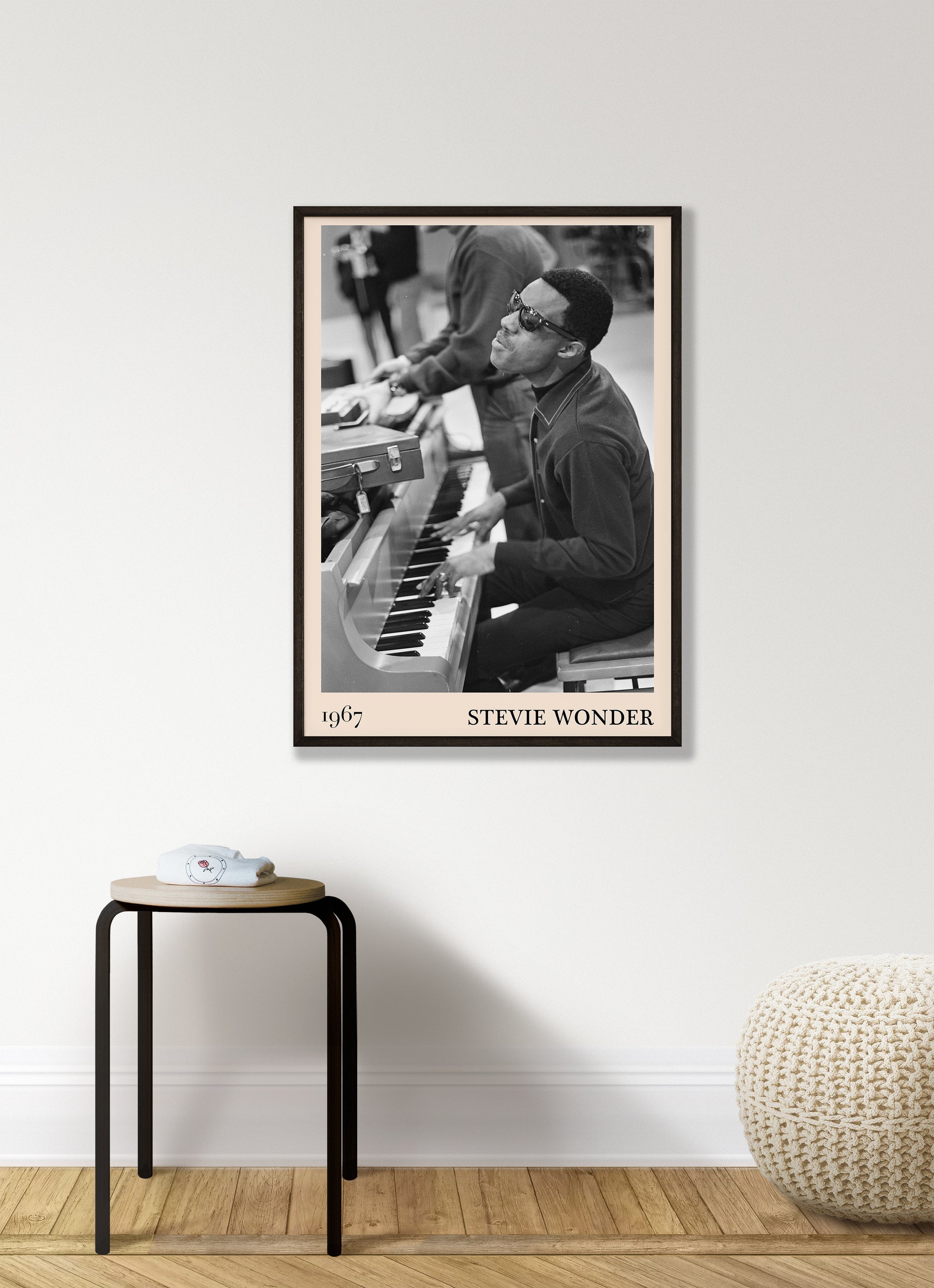 1967 photo of Stevie Wonder, crafted into an elegant black-framed print. Hanging on a white living room wall