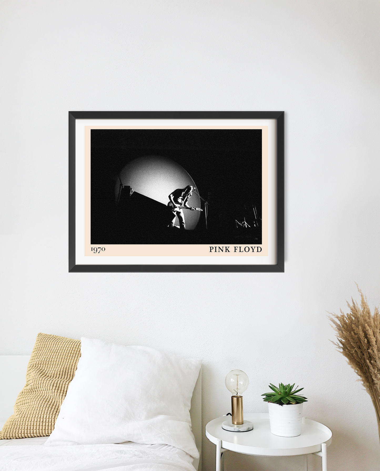 Pink Floyd Retro Rock Poster in landscape 20 mount mockup above a white bed, features black and white concert photo.