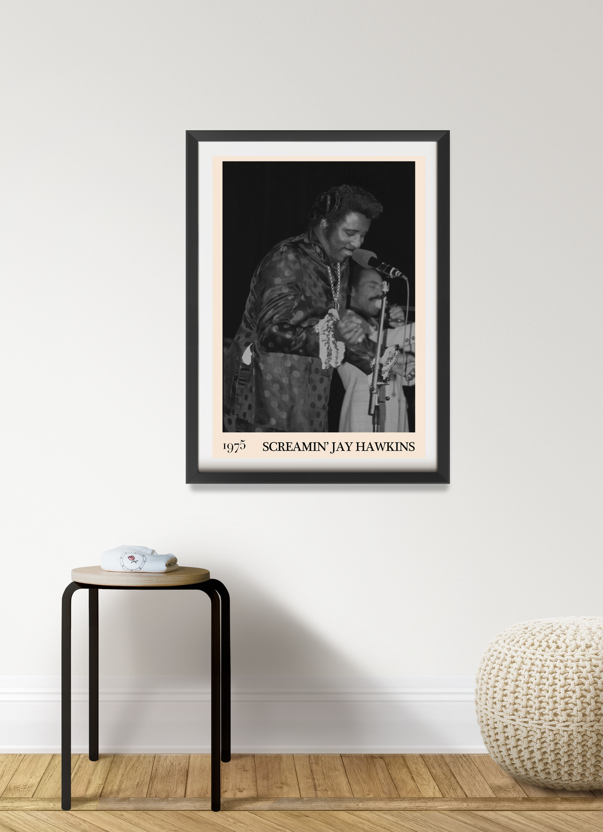 Framed print of Screamin Jay Hawkins performing live in 1975, black and white photo with peach mount, hung above a wooden
