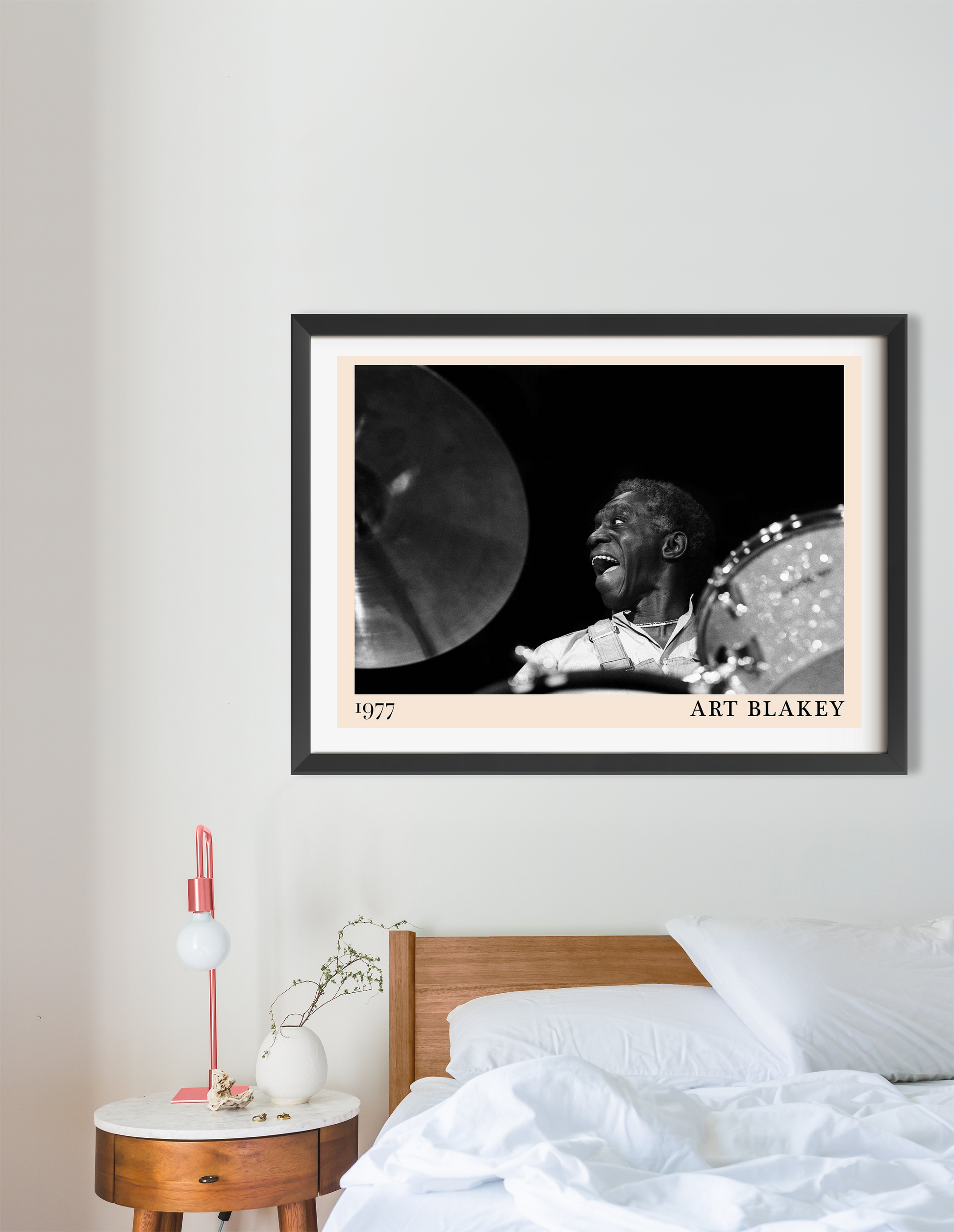 Art Blakey vintage jazz poster in a black frame, landscape mount above a modern wooden bed and nightstand in a minimalist bed