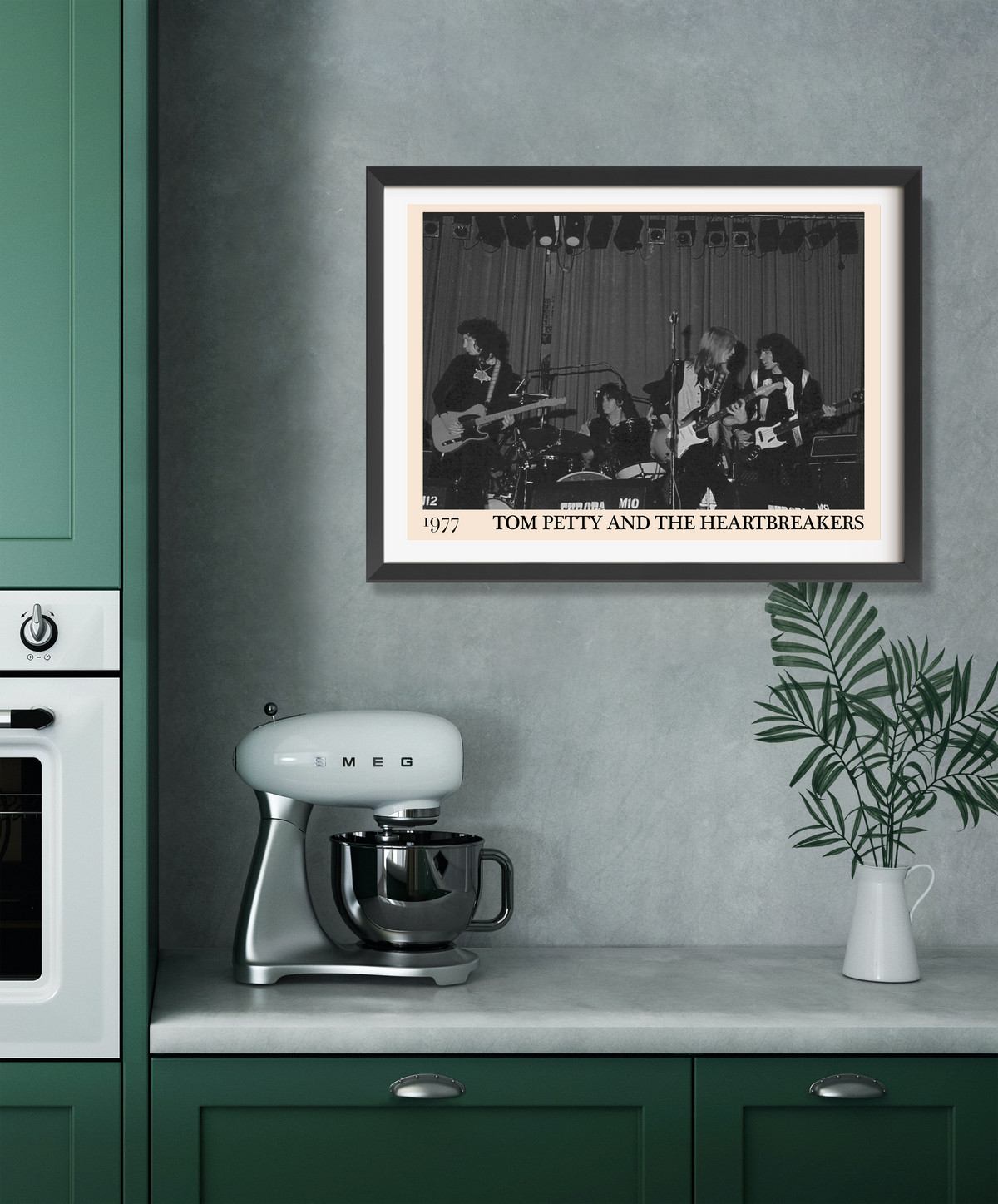 Framed print of Tom Petty and the Heartbreakers 1977 concert in black and white, hung above a kitchen worktop with a Smeg