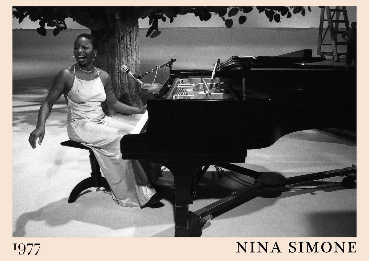 Poster featuring a black and white 1977 photo of Nina Simone smiling at a grand piano, with a tree backdrop and beige border,