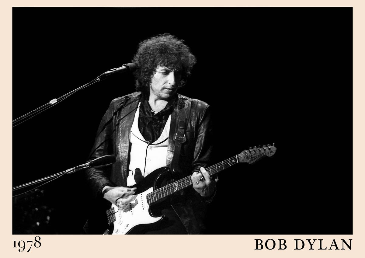 Poster featuring Bob Dylan playing electric guitar on stage, 1978, in black and white with beige border and bold text, retro
