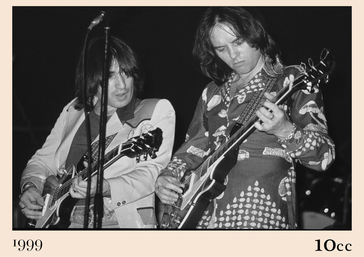 Black and white photo of 10cc's Eric Stewart and Lol Creme playing electric guitars side by side on stage