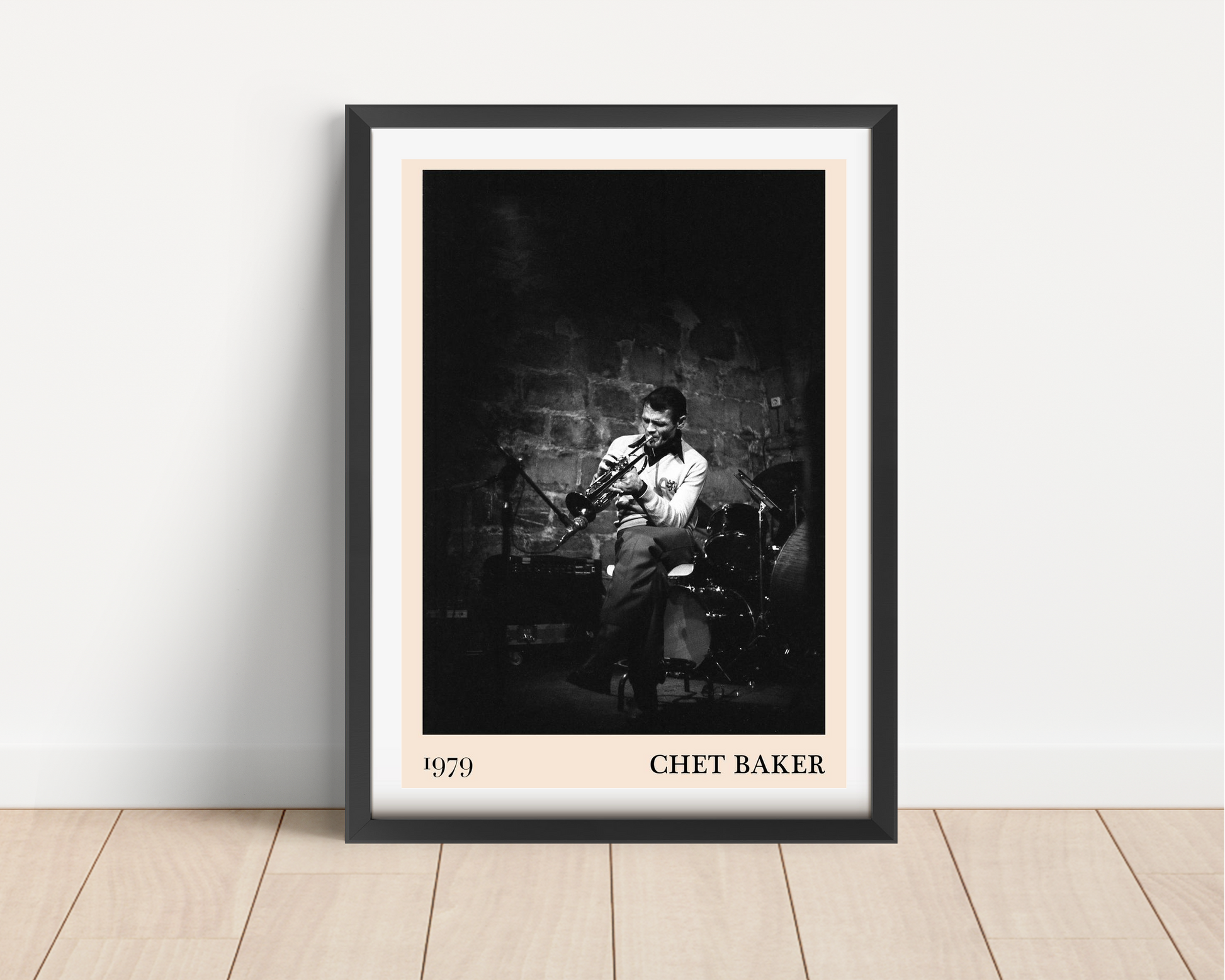 Chet Baker vintage concert poster in black frame, portrait mount mockup on wood floor, features jazz musician on stage.