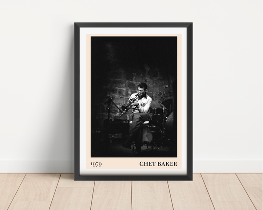 Chet Baker vintage concert poster in black frame, portrait mount mockup on wood floor, features jazz musician on stage.