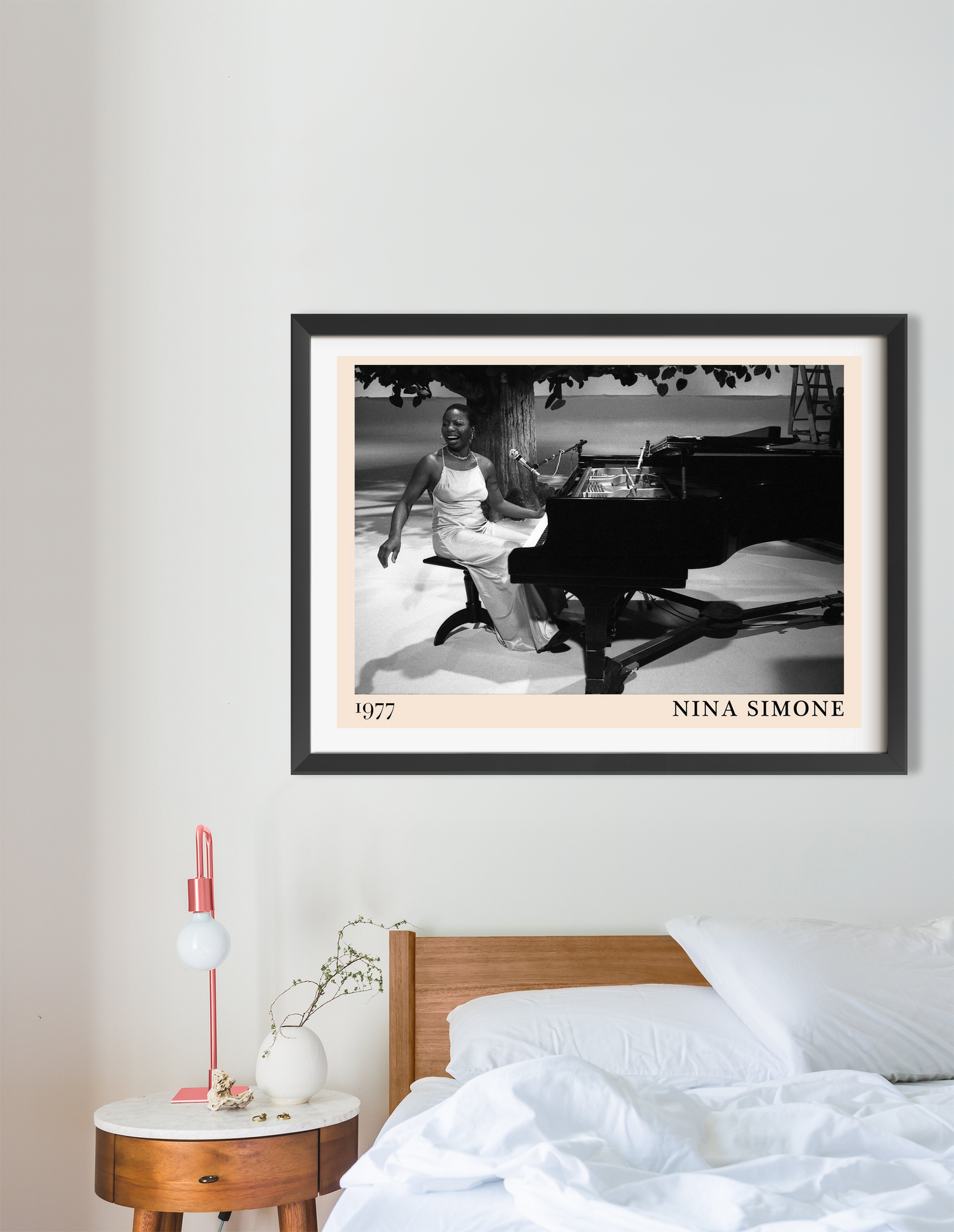 Nina Simone vintage poster in landscape 16 mount mockup above a modern bed, black and white piano scene, stylish bedroom deco