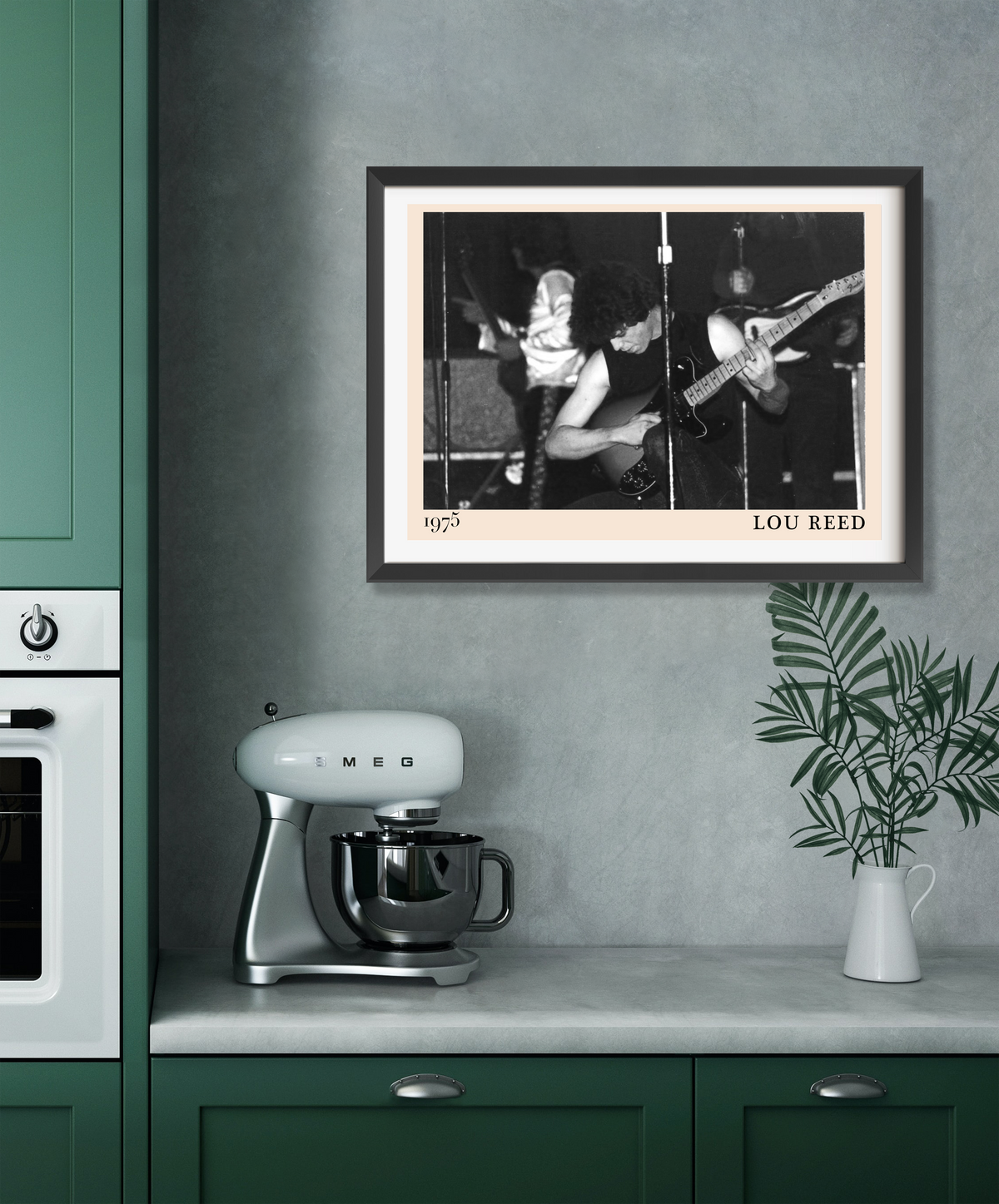 Lou Reed 1975 framed print displayed in a dark-framed landscape mount above a green kitchen worktop with a retro Smeg stand