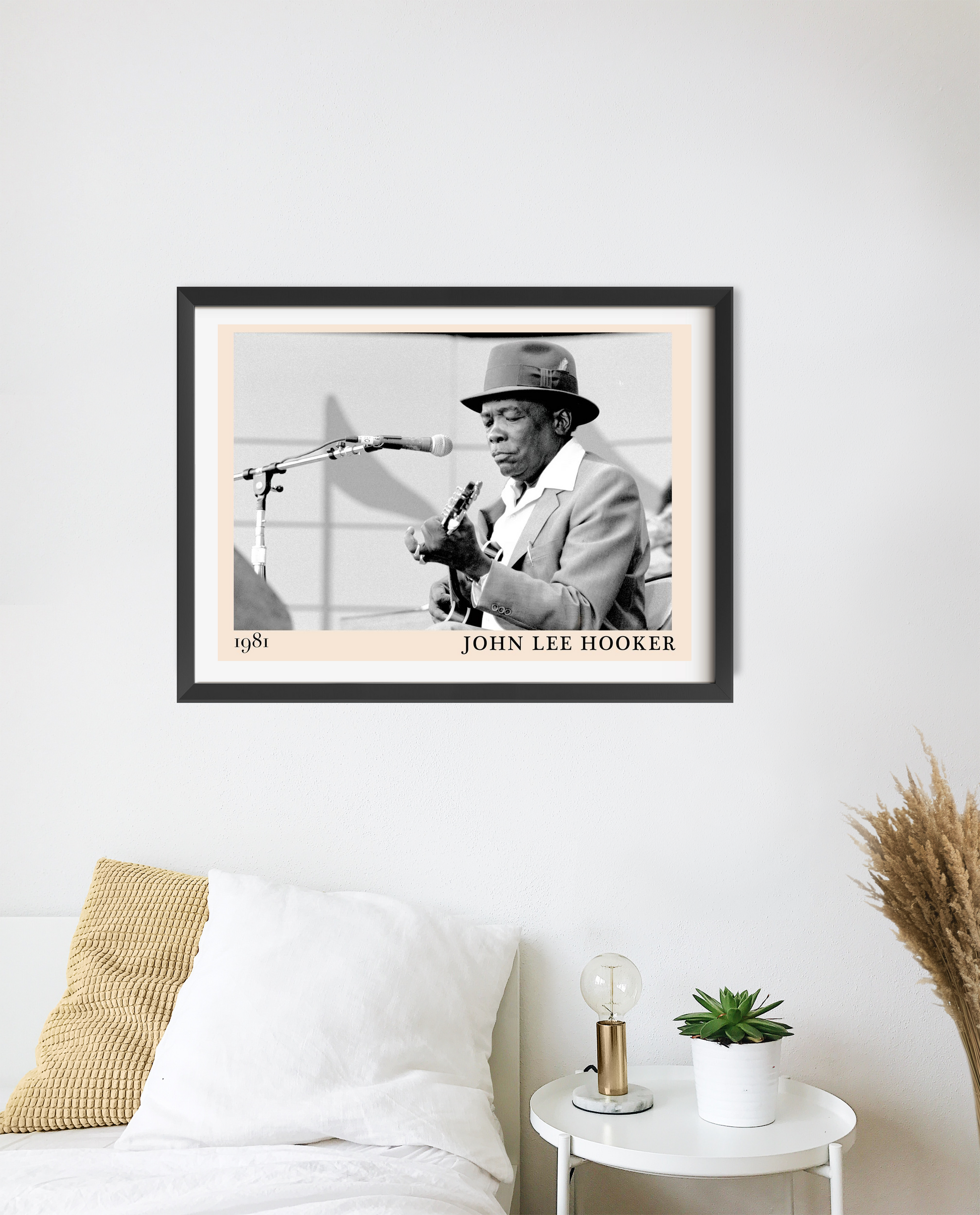 John Lee Hooker Blues Poster in landscape frame mockup above a modern bed, featuring vintage black and white musician design.