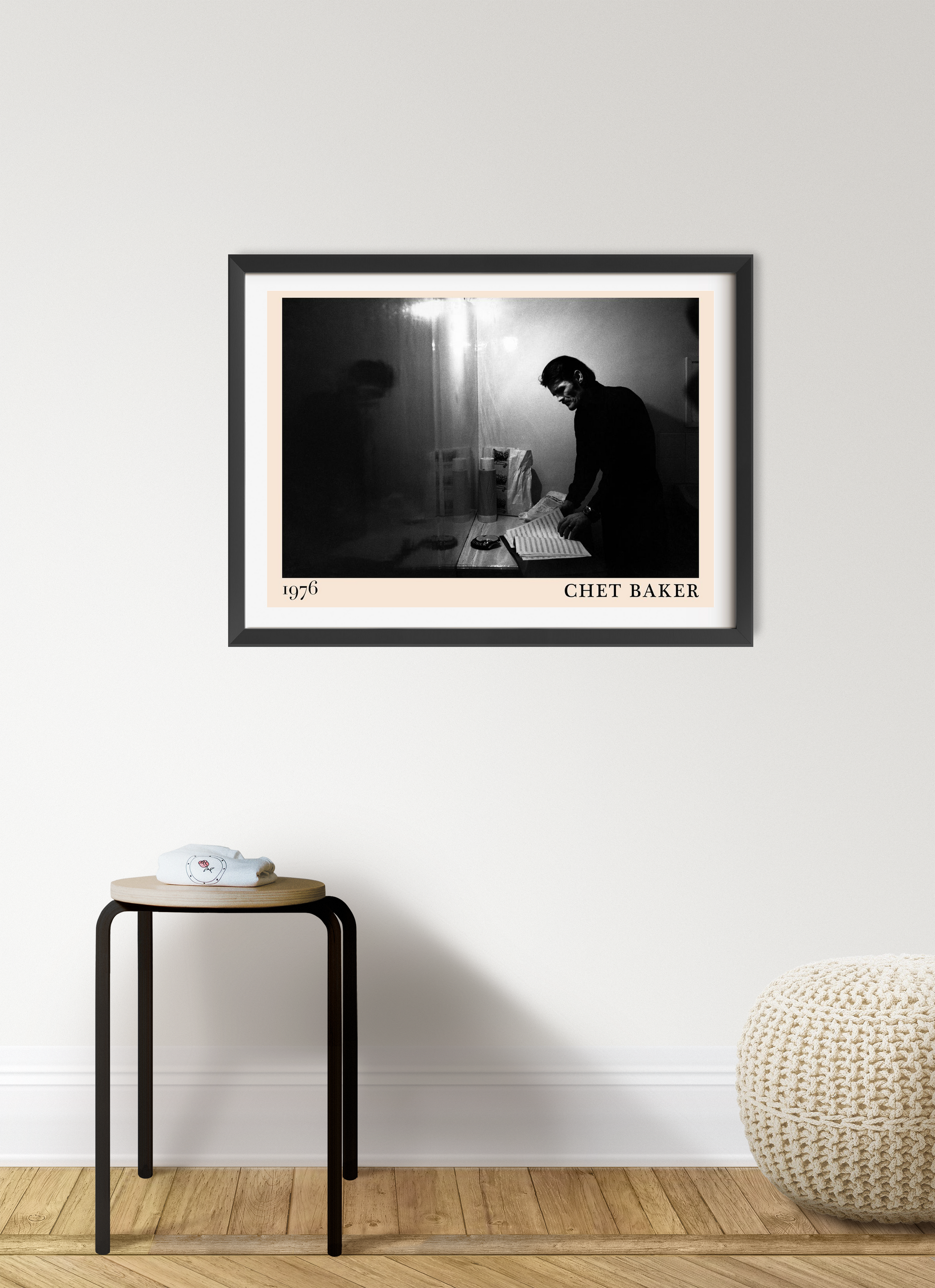 Chet Baker Retro Jazz Poster in landscape 7 mount mockup, black and white design on wall above stool in modern room setting.