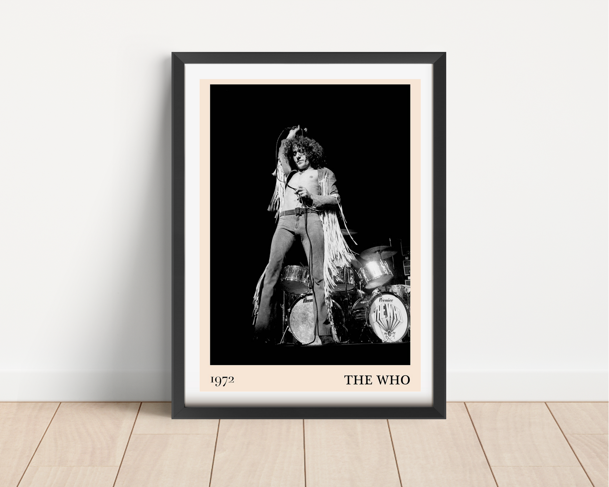 The Who vintage concert poster mockup in a black frame, featuring 1972 band photo and bold typography, on wood floor.