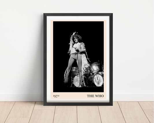 The Who vintage concert poster mockup in a black frame, featuring 1972 band photo and bold typography, on wood floor.