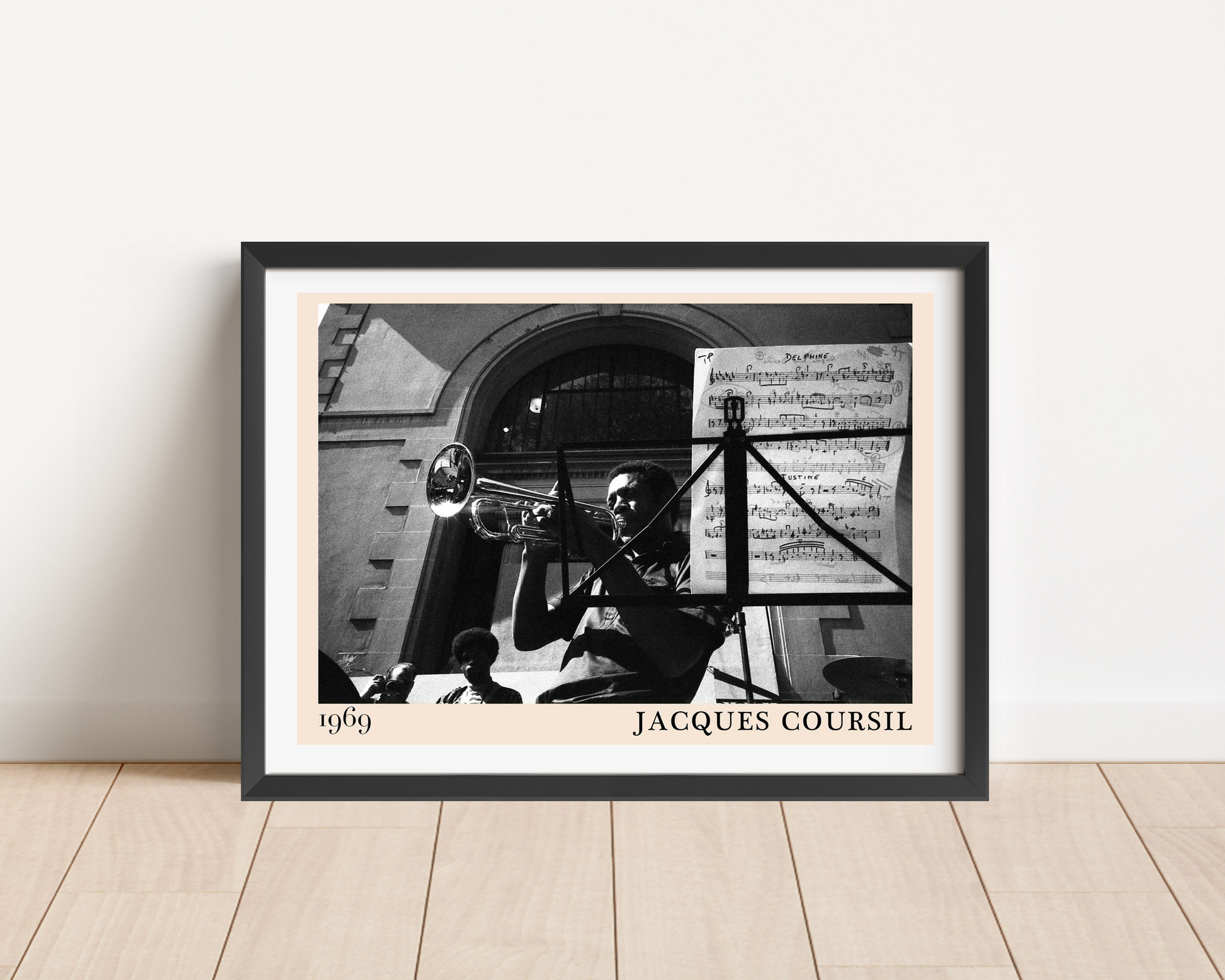 Jacques Coursil vintage jazz poster in landscape main mount mockup, black frame on wood floor, 1969 trumpet photo design