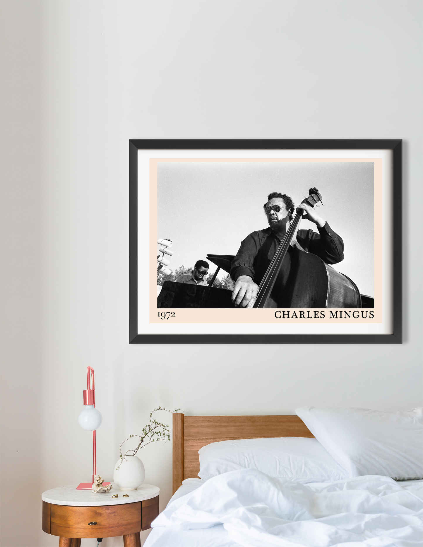 Charles Mingus Cool Jazz Poster in landscape 16 mount above modern wood bed, black and white jazz design with bold border.