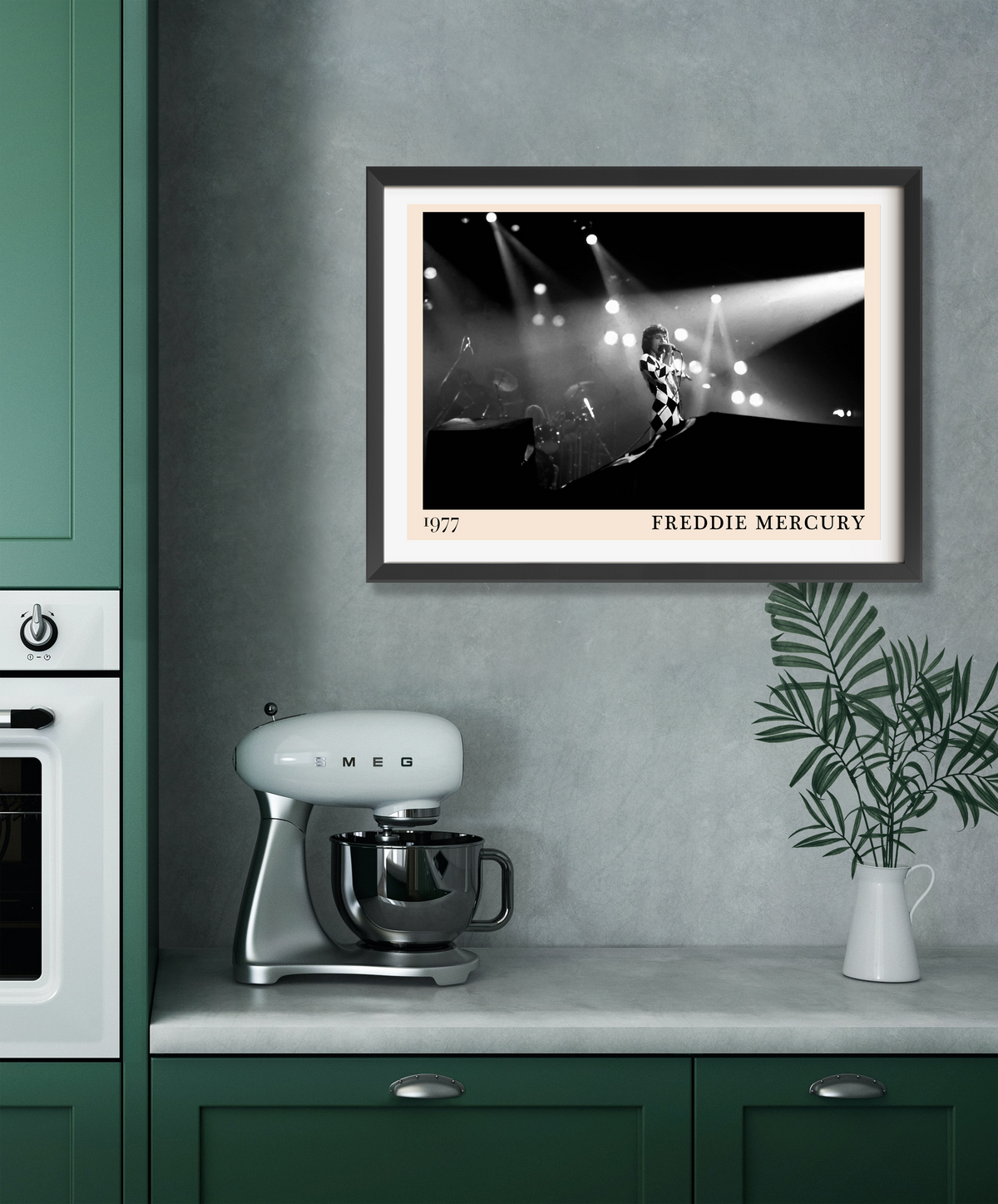 Freddie Mercury 1977 framed print in dark frame, black and white concert photo, hanging in a modern green kitchen above a