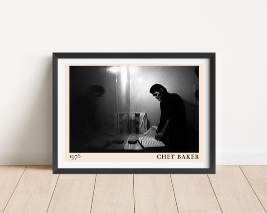 Chet Baker Retro Jazz Poster in landscape frame mockup, black and white 1976 design leaning on light wood floor.