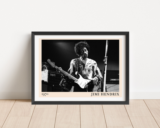 Jimi Hendrix Retro Concert Poster in a landscape frame mockup, black and white 1970 guitar photo on wood floor against wall.