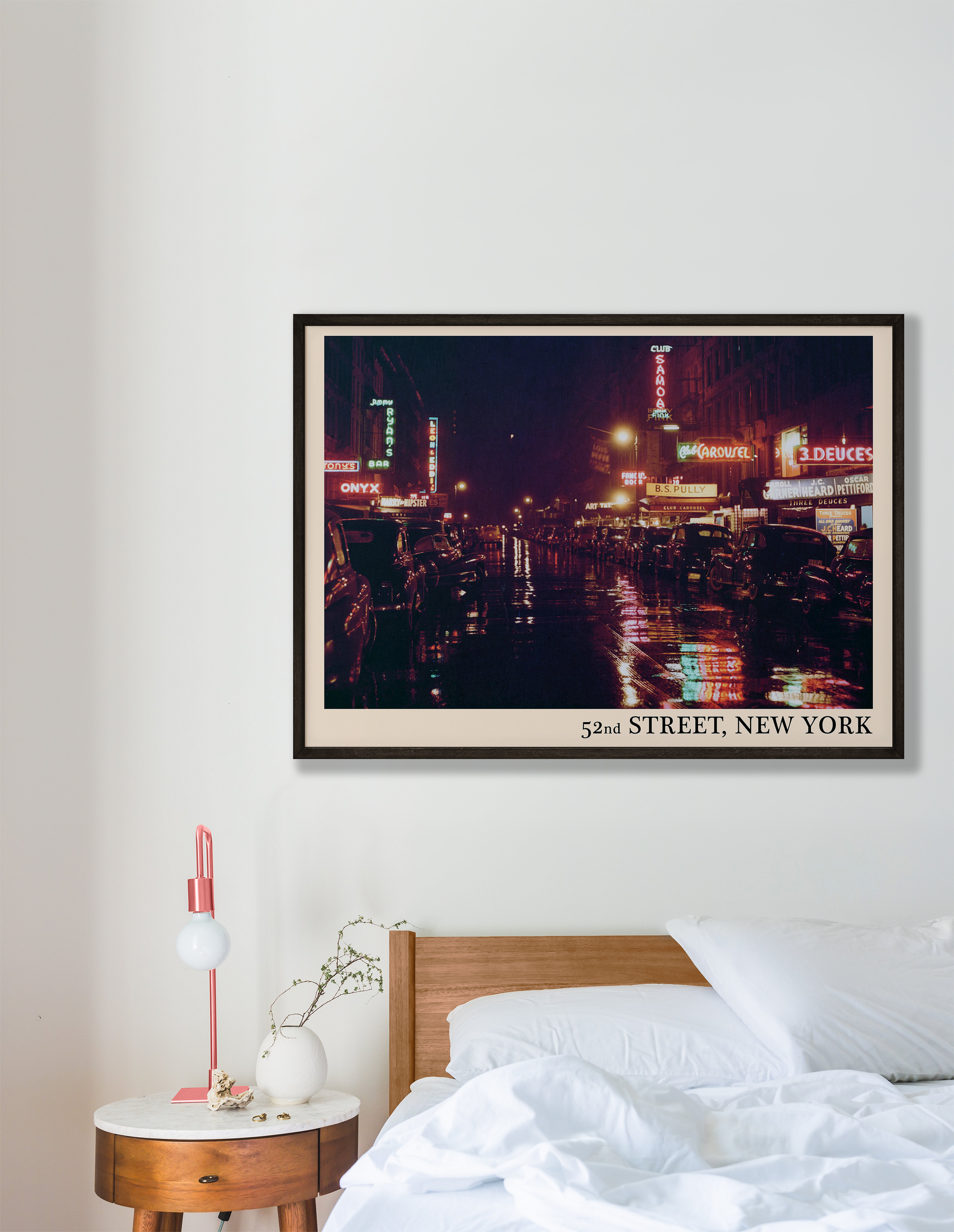 Iconic 52nd Street in New York captured in a retro black framed jazz print, hanging on a white bedroom wall