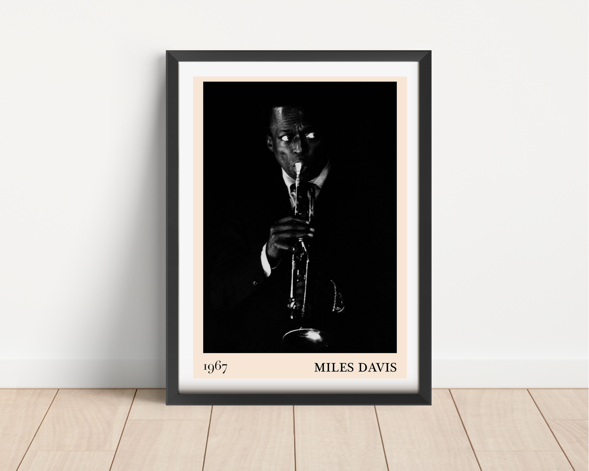 Miles Davis vintage jazz poster in black frame, portrait mount on light wall, features 1967 monochrome trumpet player design