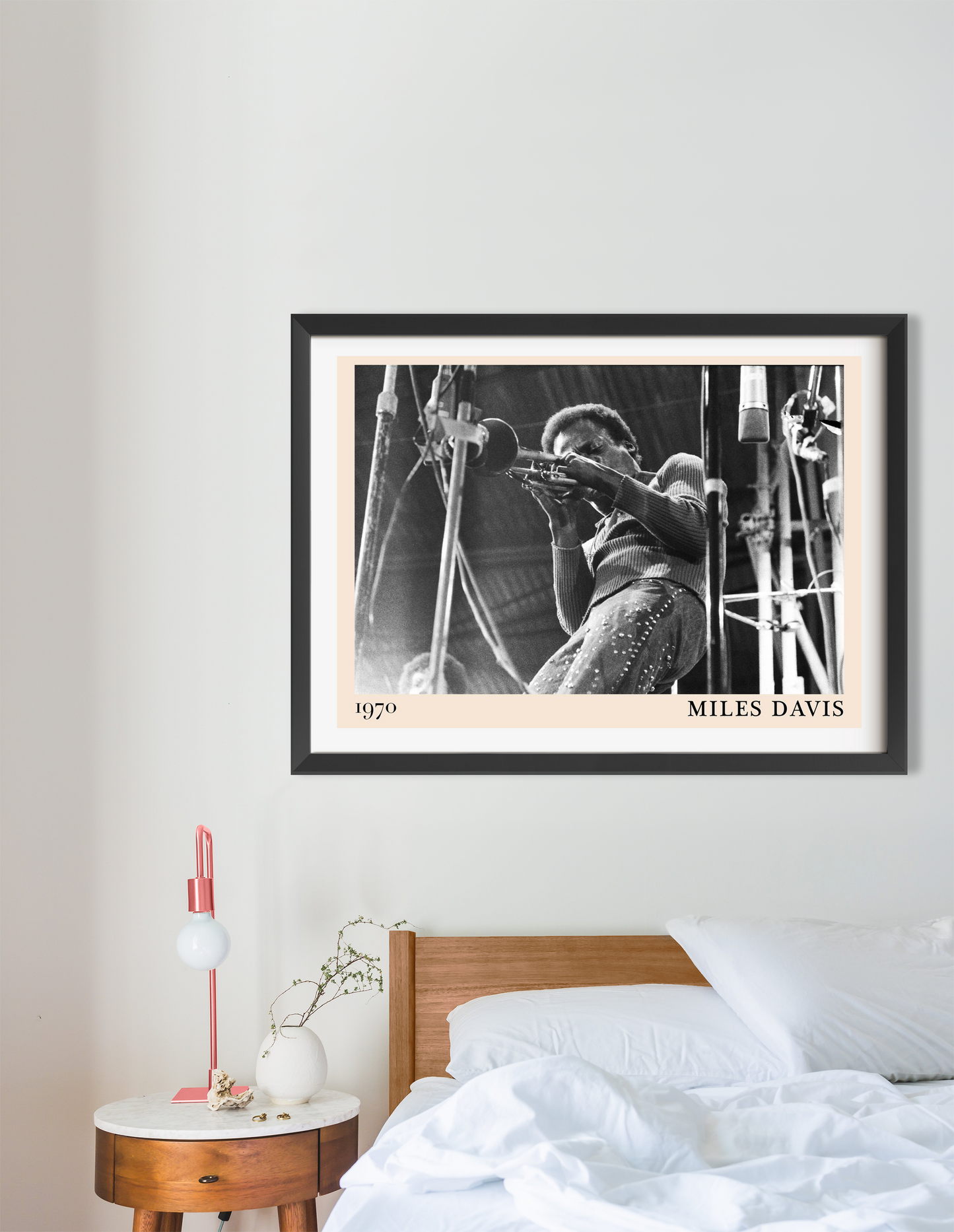 Miles Davis Jazz Concert Poster in landscape 16 mount, black and white 1970 design above modern bed and nightstand decor.