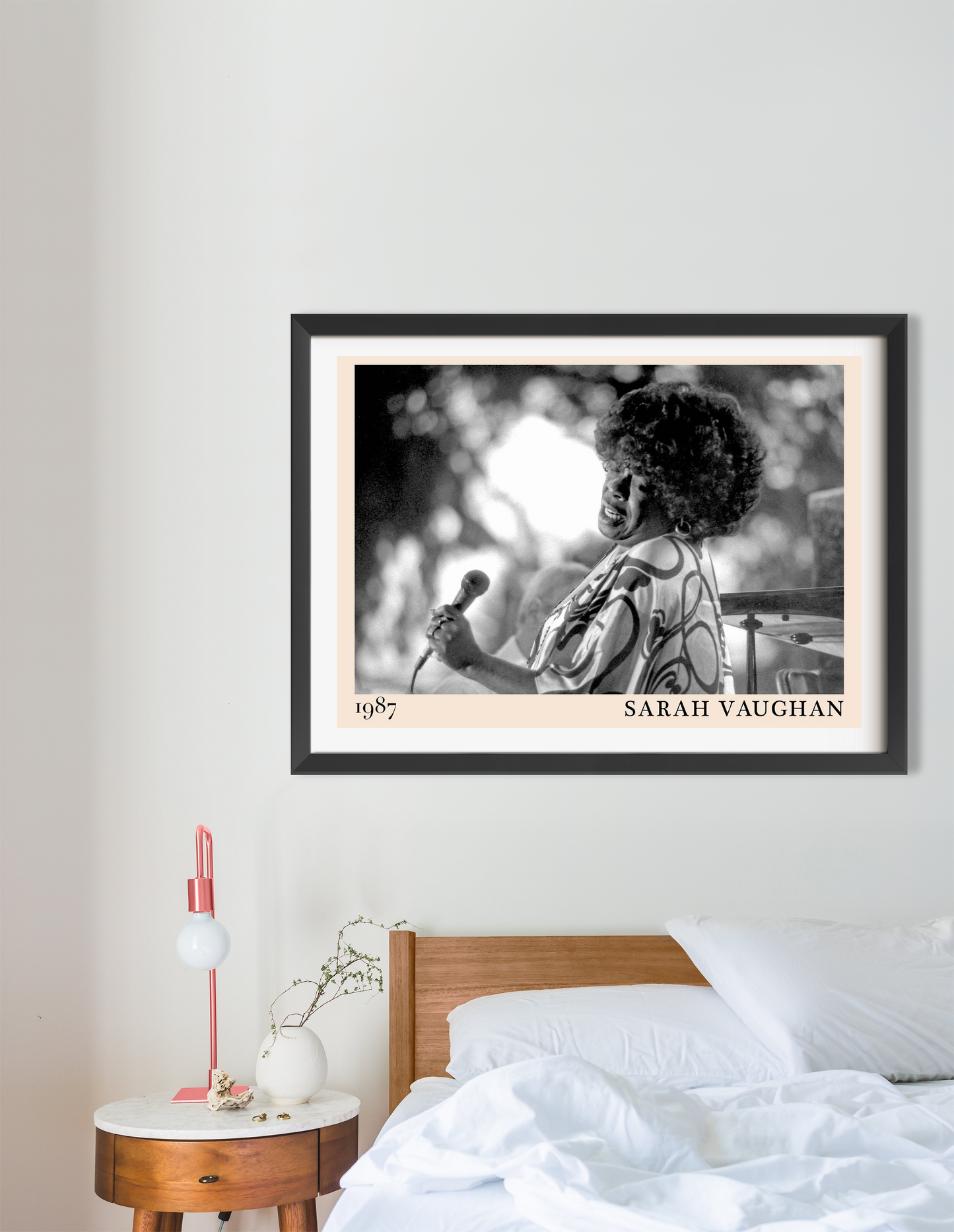Sarah Vaughan Jazz Poster in landscape 16 mount above a modern bed, featuring black and white singer portrait and minimal dec