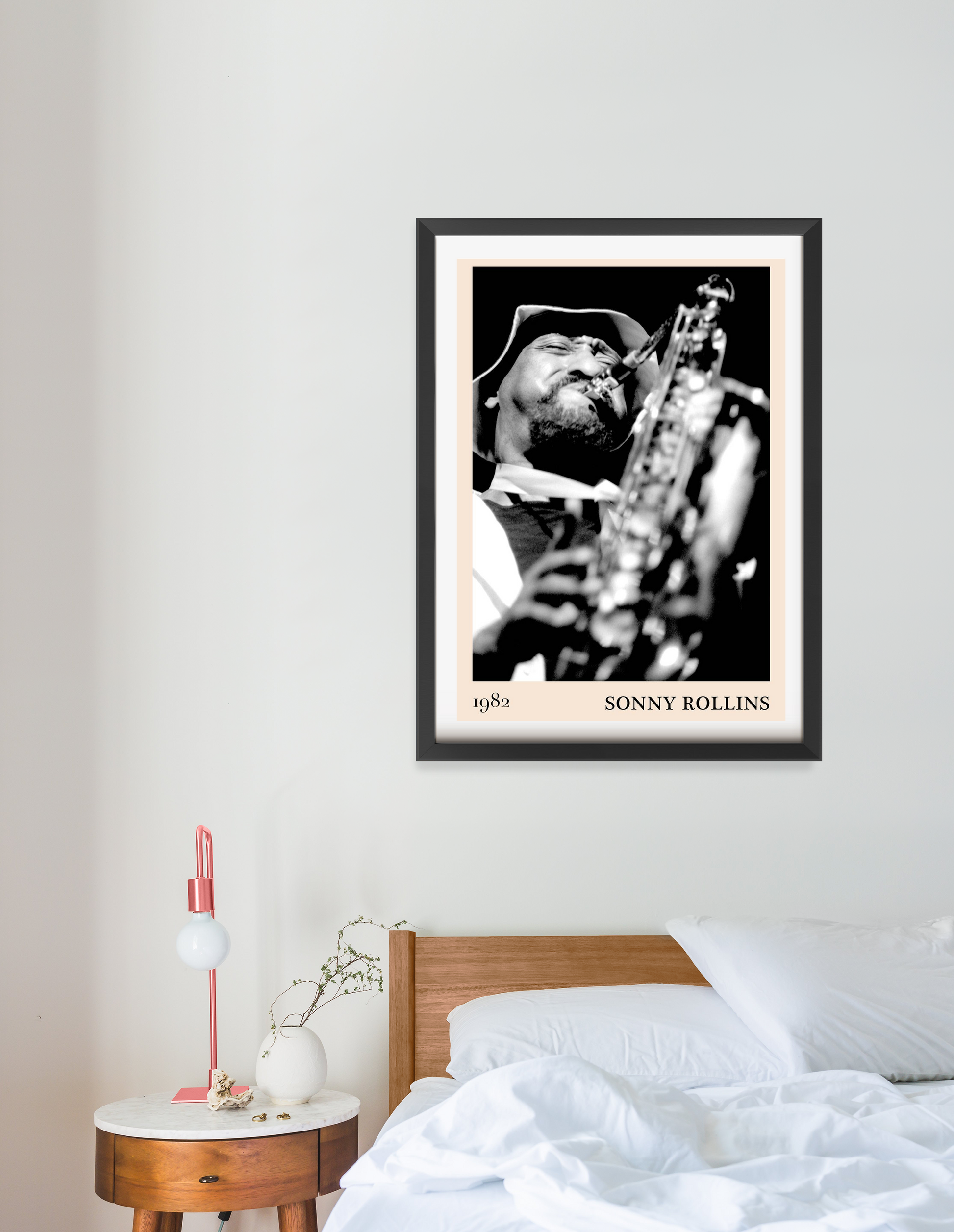 Sonny Rollins Jazz Concert Poster in a portrait 16 mount frame above a modern bed, featuring bold black and white saxophone d