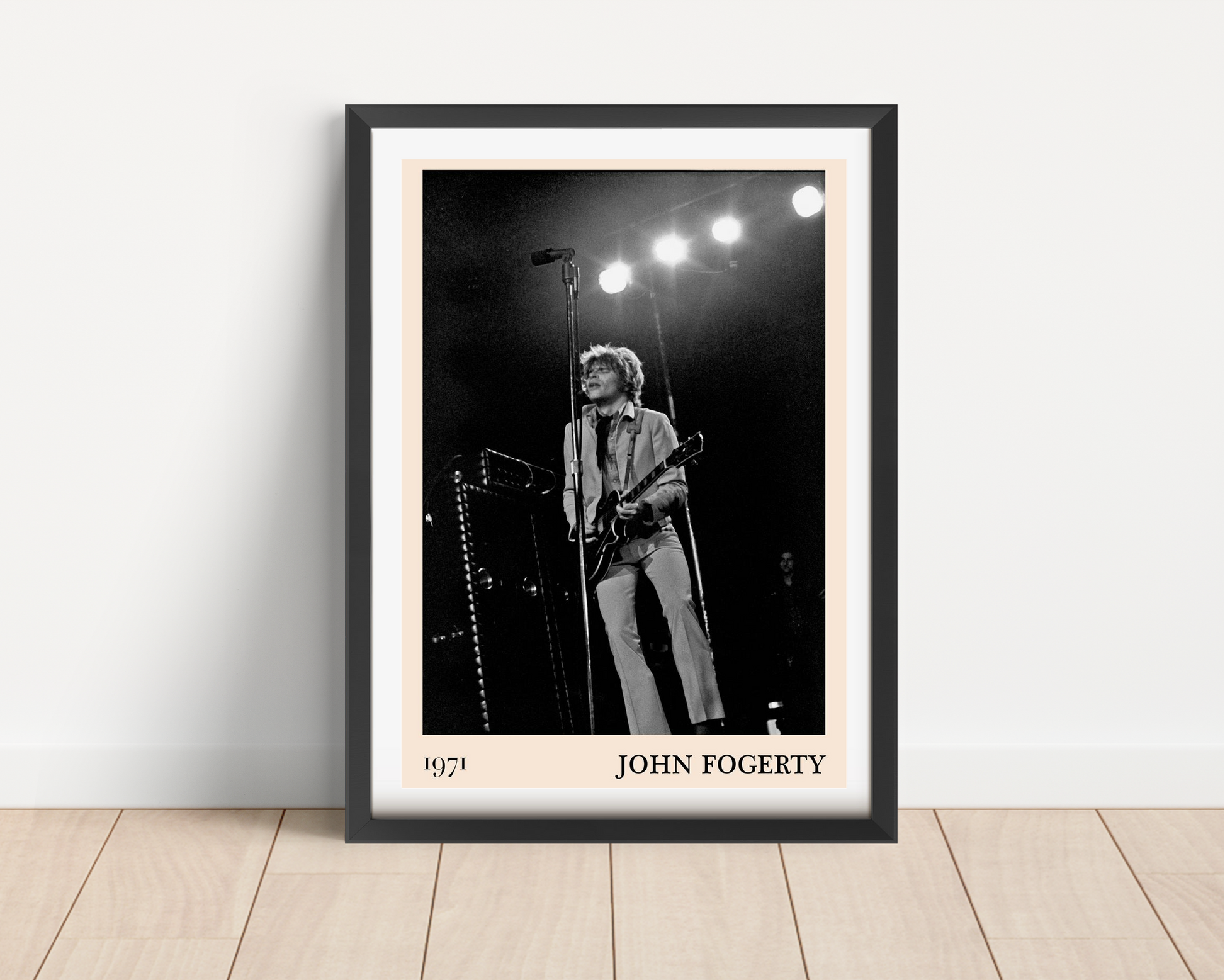 John Fogerty Retro Rock Poster in black frame, portrait mount mockup on wooden floor, vintage 1971 concert design style