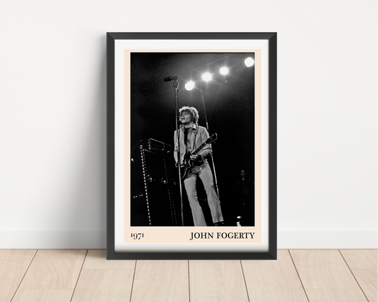 John Fogerty Retro Rock Poster in black frame, portrait mount mockup on wooden floor, vintage 1971 concert design style