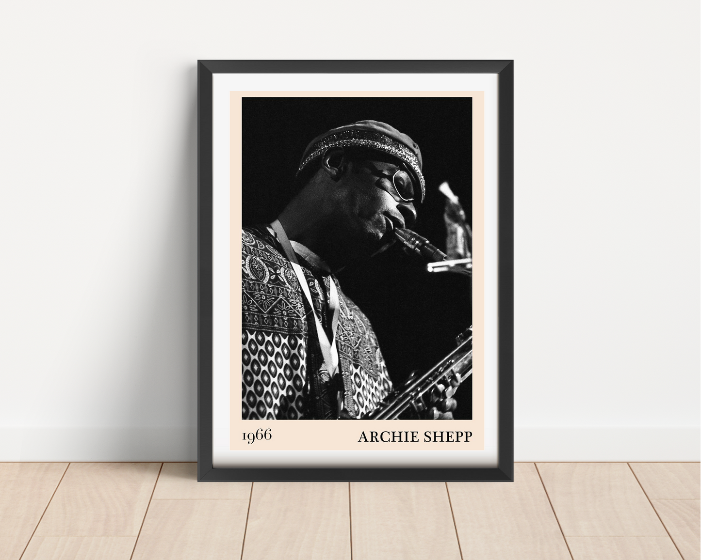Archie Shepp Jazz Concert Poster in portrait main mount mockup, black frame, 1966 design, on wooden floor against white wall