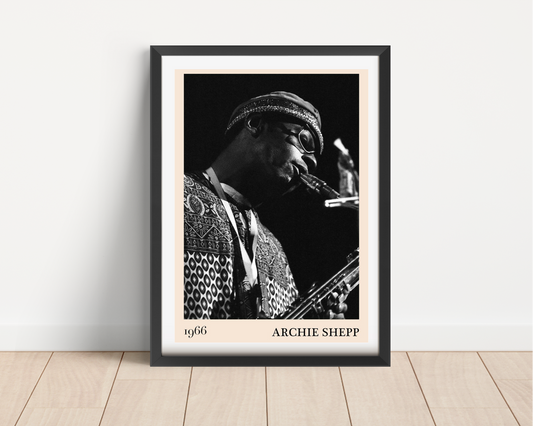 Archie Shepp Jazz Concert Poster in portrait main mount mockup, black frame, 1966 design, on wooden floor against white wall
