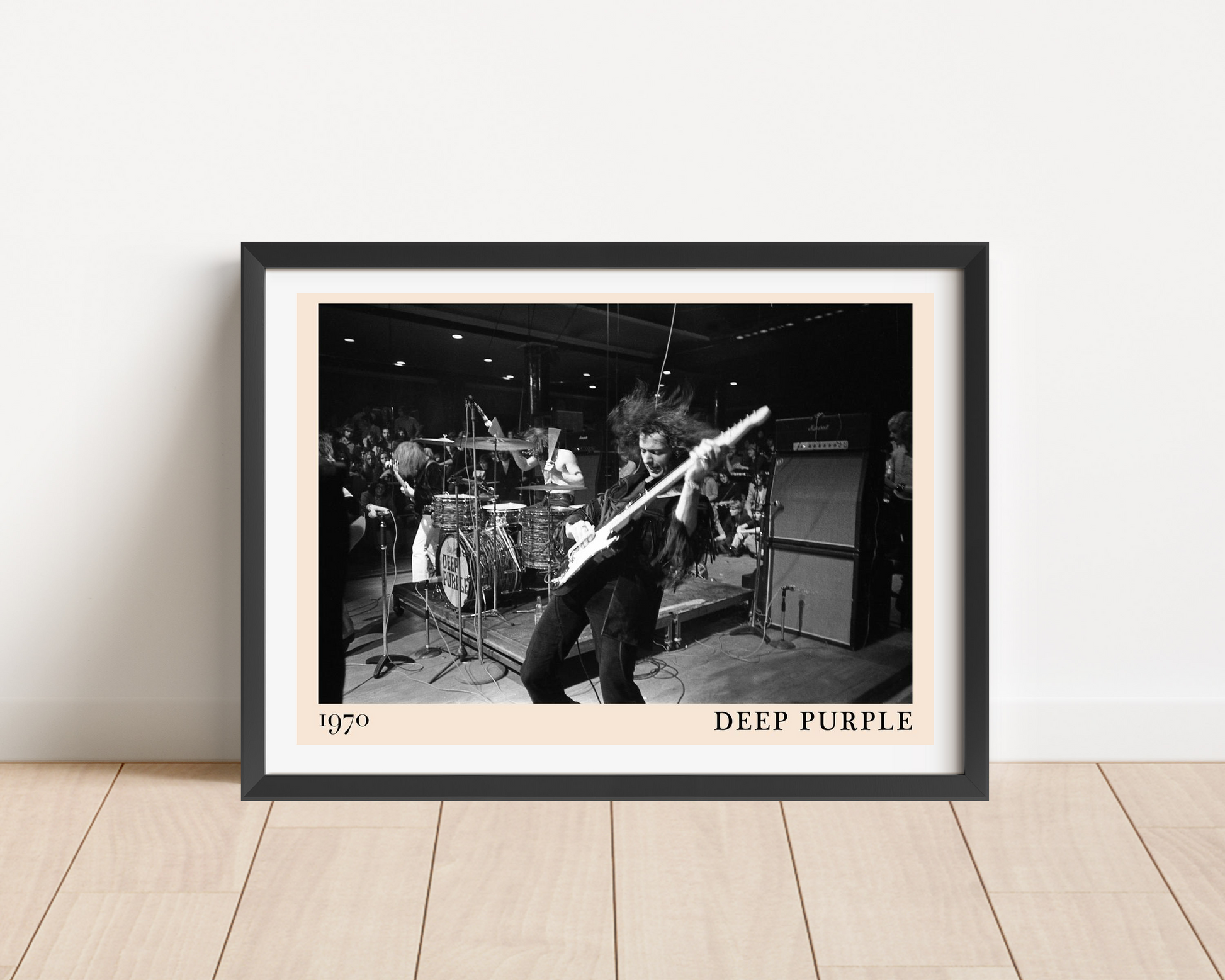 Deep Purple rock concert poster in landscape mount mockup, black and white band photo with bold text, leaning on wood floor