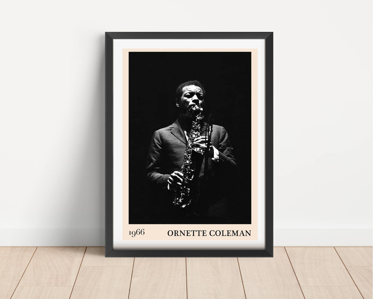 Ornette Coleman vintage jazz poster in black frame, portrait mount, features bold monochrome saxophone design on wood floor.
