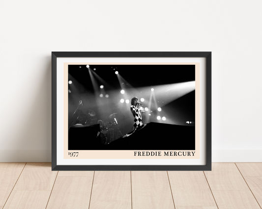 Framed Freddie Mercury 1977 black and white concert print in a black frame, leaning against a white wall on a light wood
