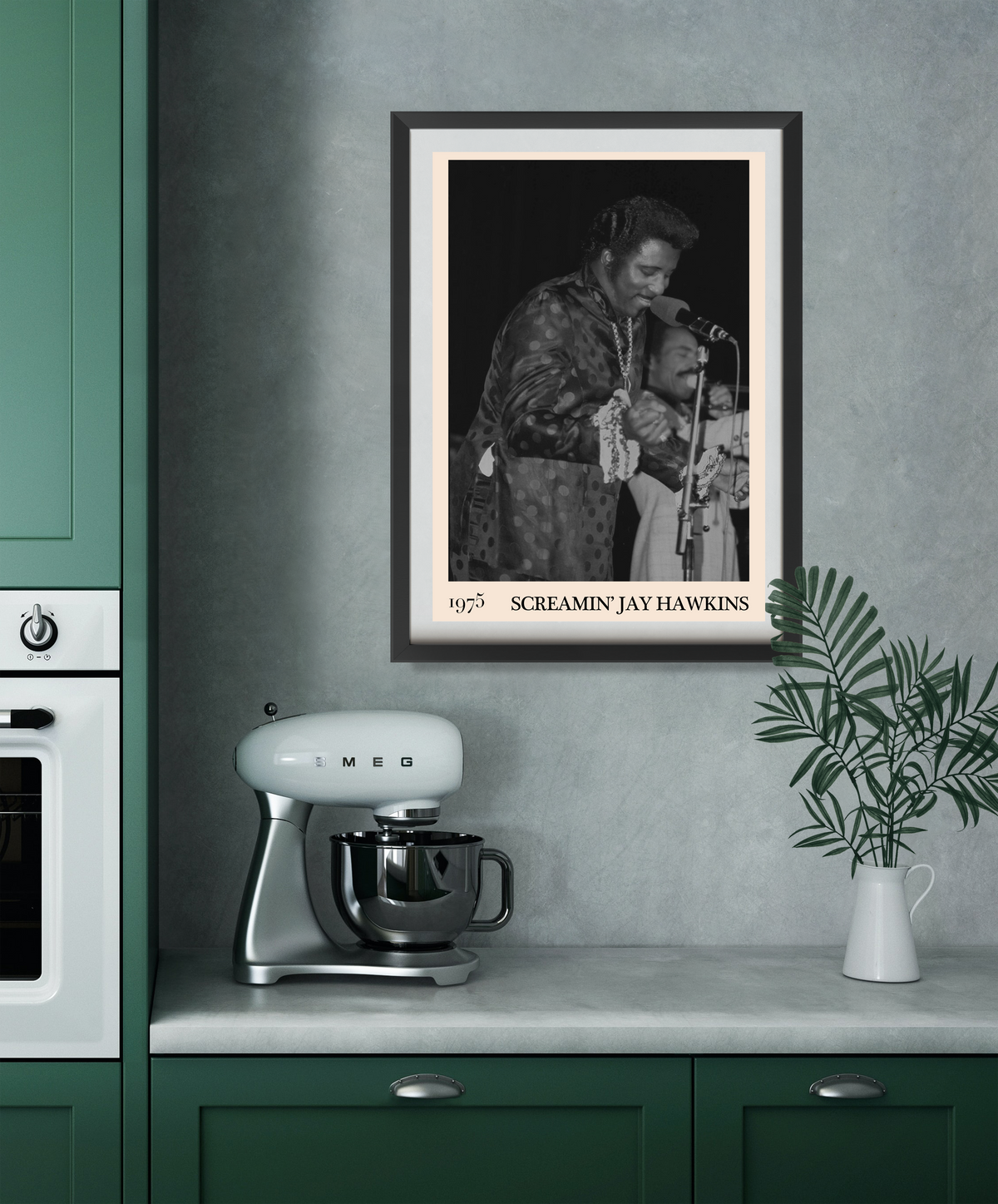Framed Screamin Jay Hawkins 1975 concert print in a dark frame, hung on a grey kitchen wall above a retro Smeg stand mixer.
