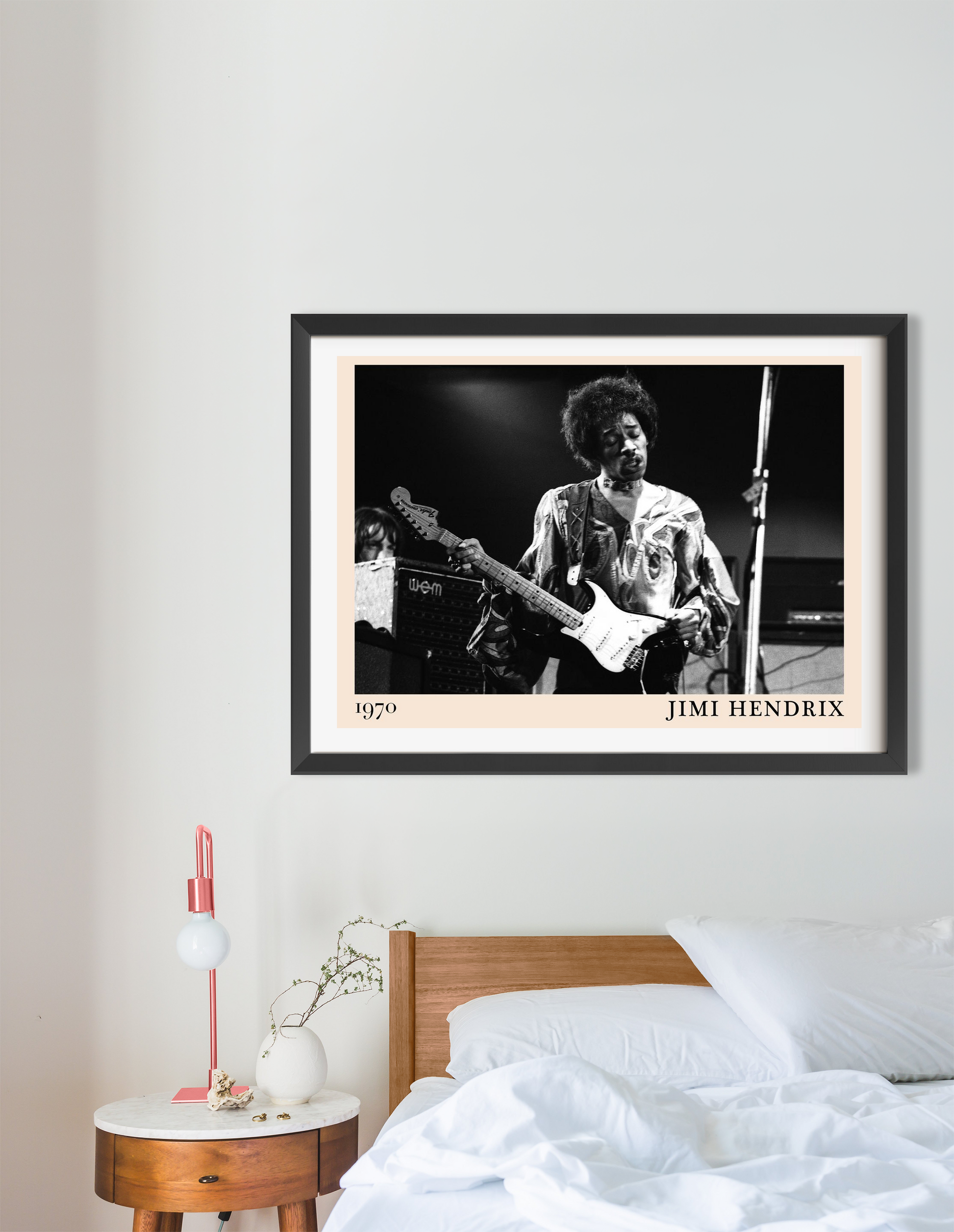Jimi Hendrix retro concert poster in landscape 16 mount mockup, black and white guitar design above modern bedroom decor.