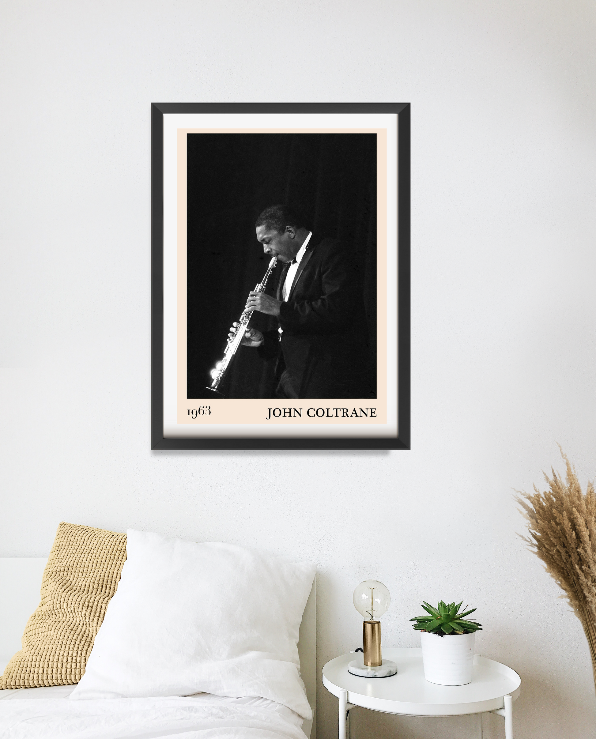 John Coltrane Jazz Poster in portrait 20 mount mockup, black and white musician print above modern white bedroom decor.