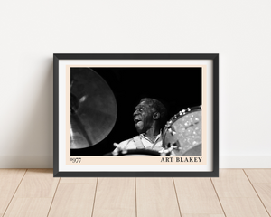 Art Blakey vintage jazz poster in landscape mount mockup, framed on a wood floor, features bold black and white drummer portr