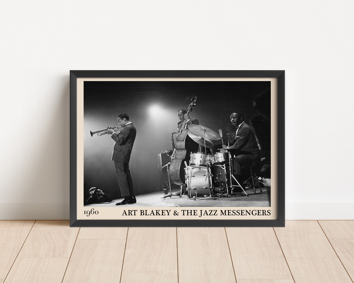 Black framed poster of Art Blakey & The Jazz Messengers against a white wall.