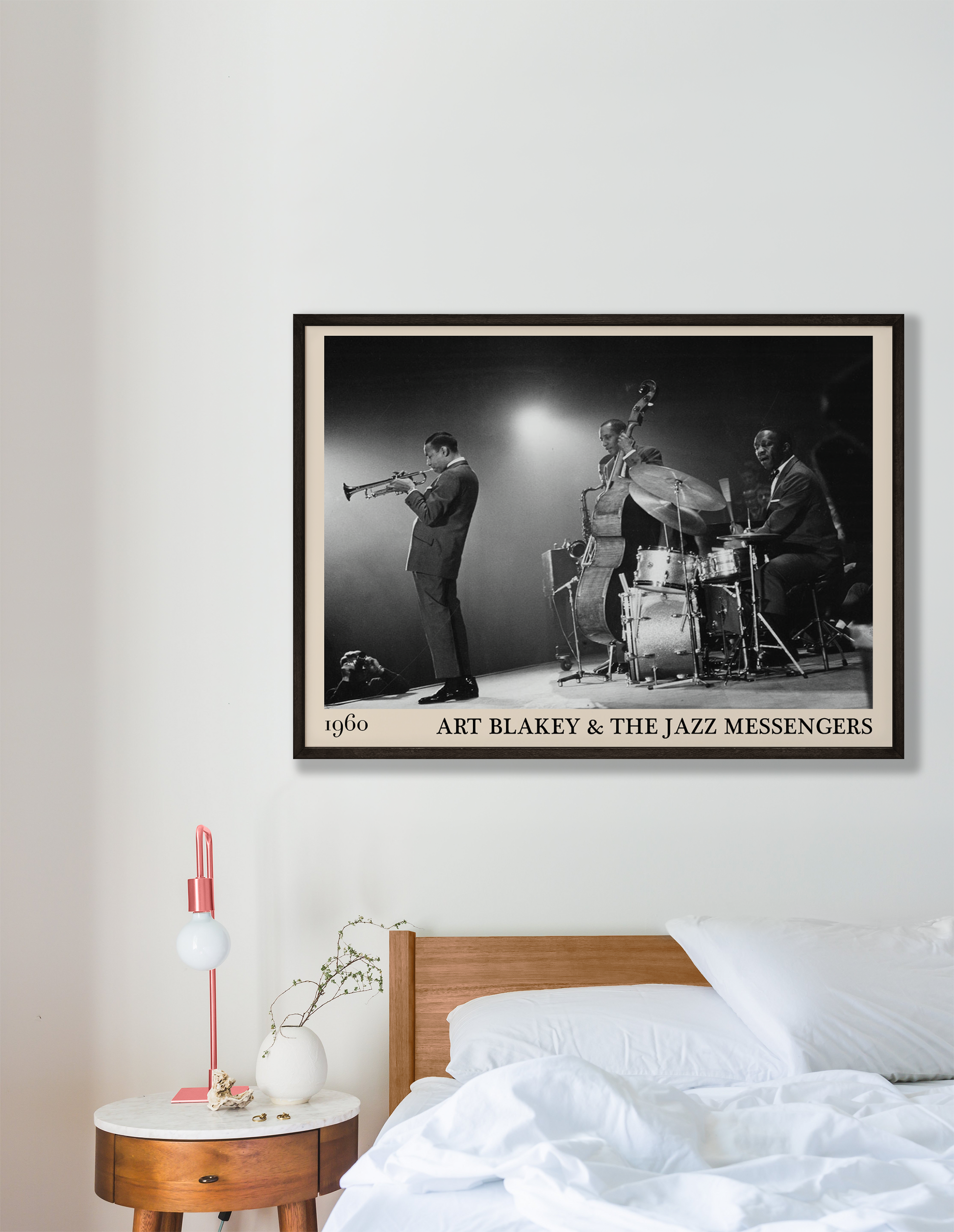 Retro framed print of Art Blakey & The Jazz Messengers hanging on a white wall in a bedroom