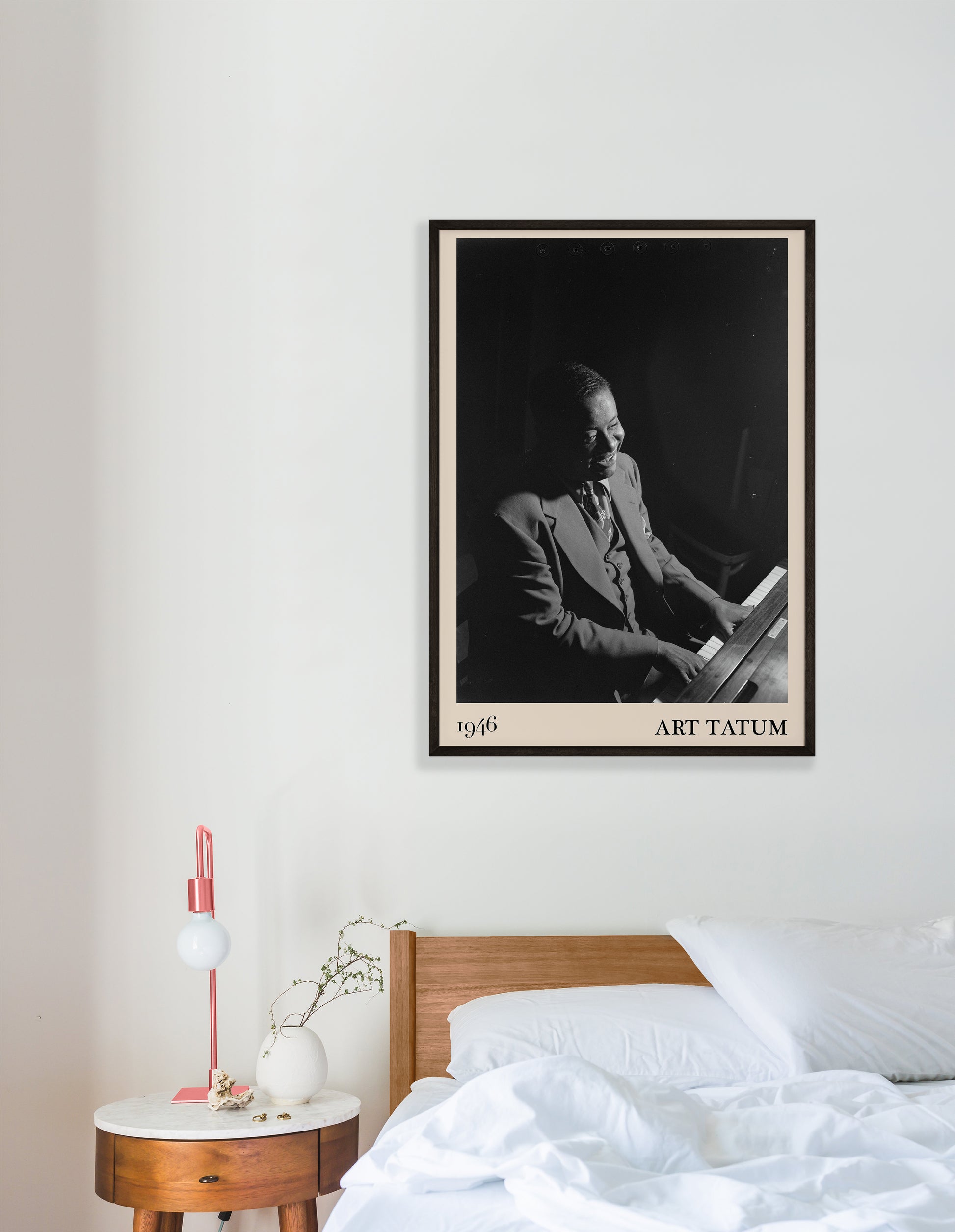 1946 photograph of Art Tatum crafted into a cool framed jazz print. The poster has an off-white border and a thin black frame. The poster is hanging on a white bedroom wall