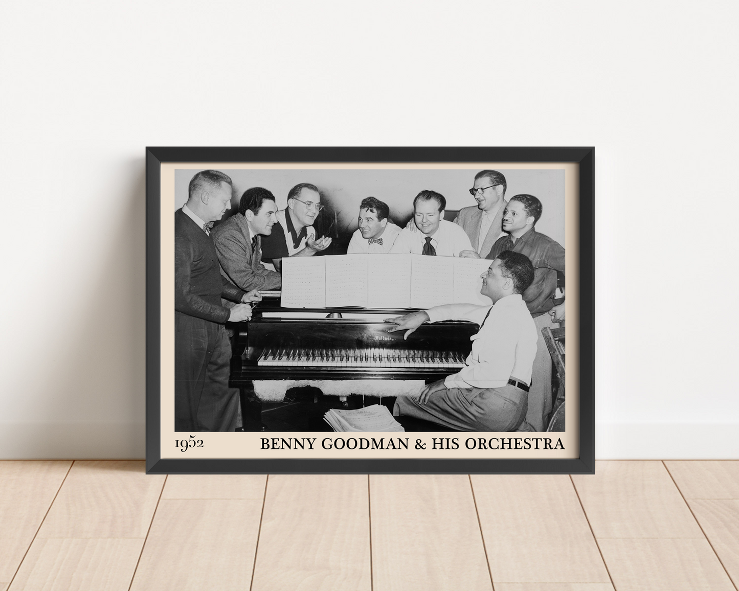 1952 photograph of Benny Goodman & his orchestra crafted into a black framed poster. The poster is resting on a white living room wall.