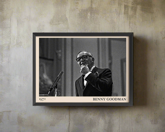 1972 photo of the Benny Goodman crafted into a black framed-poster, hanging on a pale rustic concrete wall in dappled sunlight