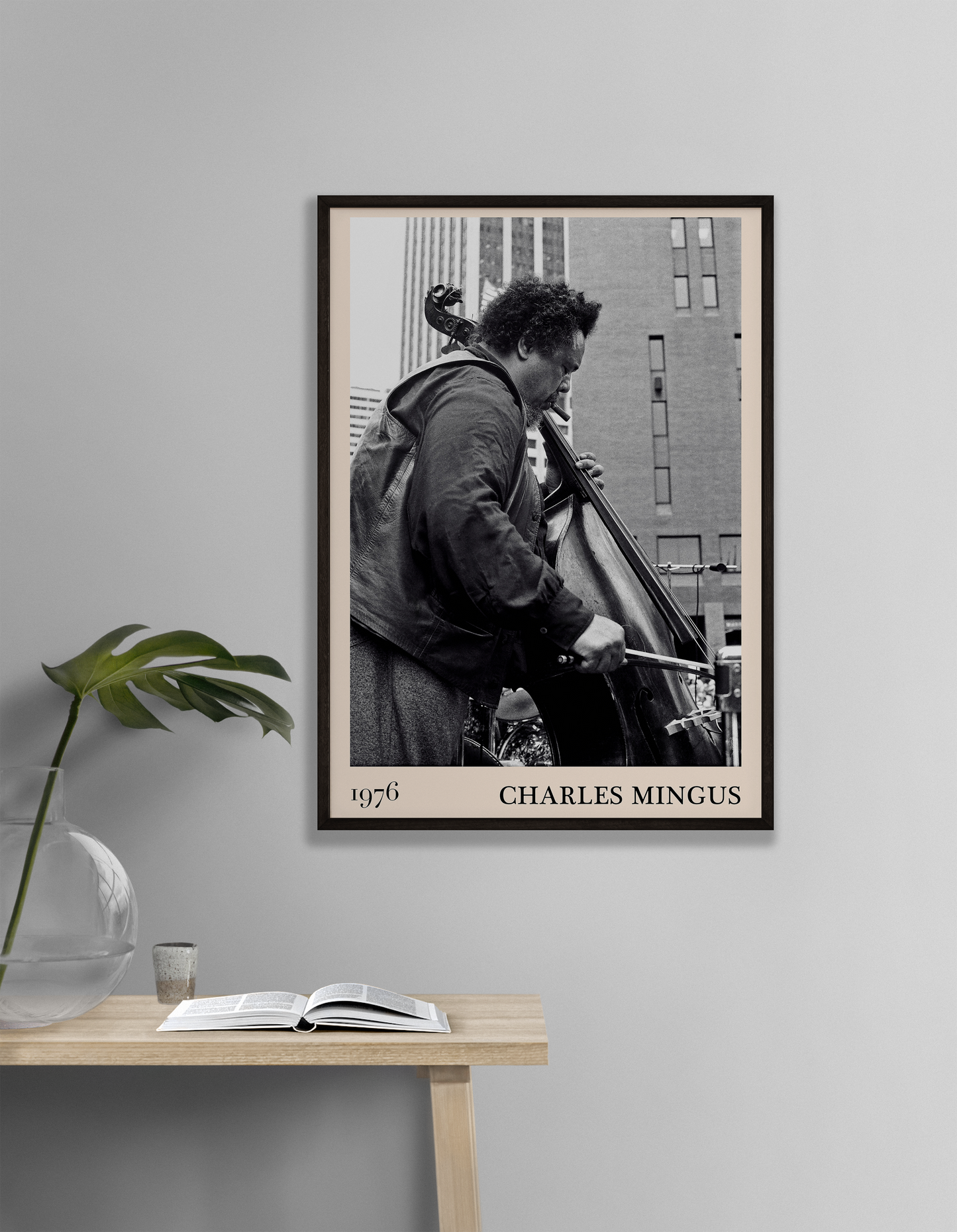 1976 photograph of Charles Mingus taken by Thomas Marcello. Picture crafted into a cool black framed music print, with an off-white border. Poster is hanging on a off-white living room wall.