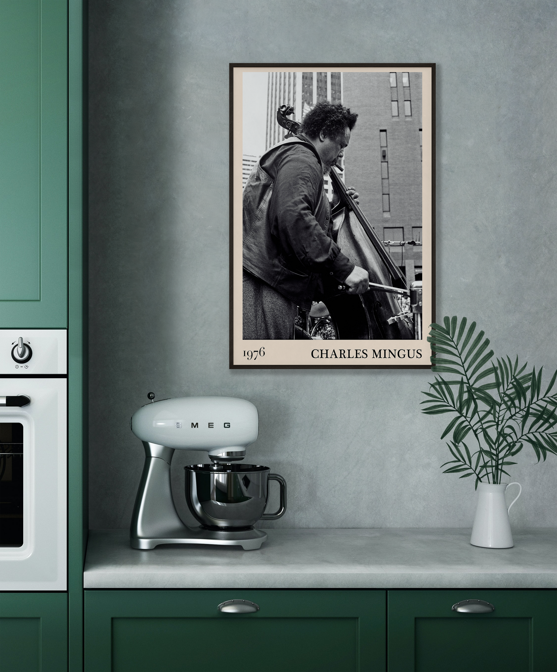 1976 photograph of Charles Mingus taken by Thomas Marcello. Picture crafted into a cool black framed music print, with an off-white border. Poster is hanging on a grey kitchen wall.