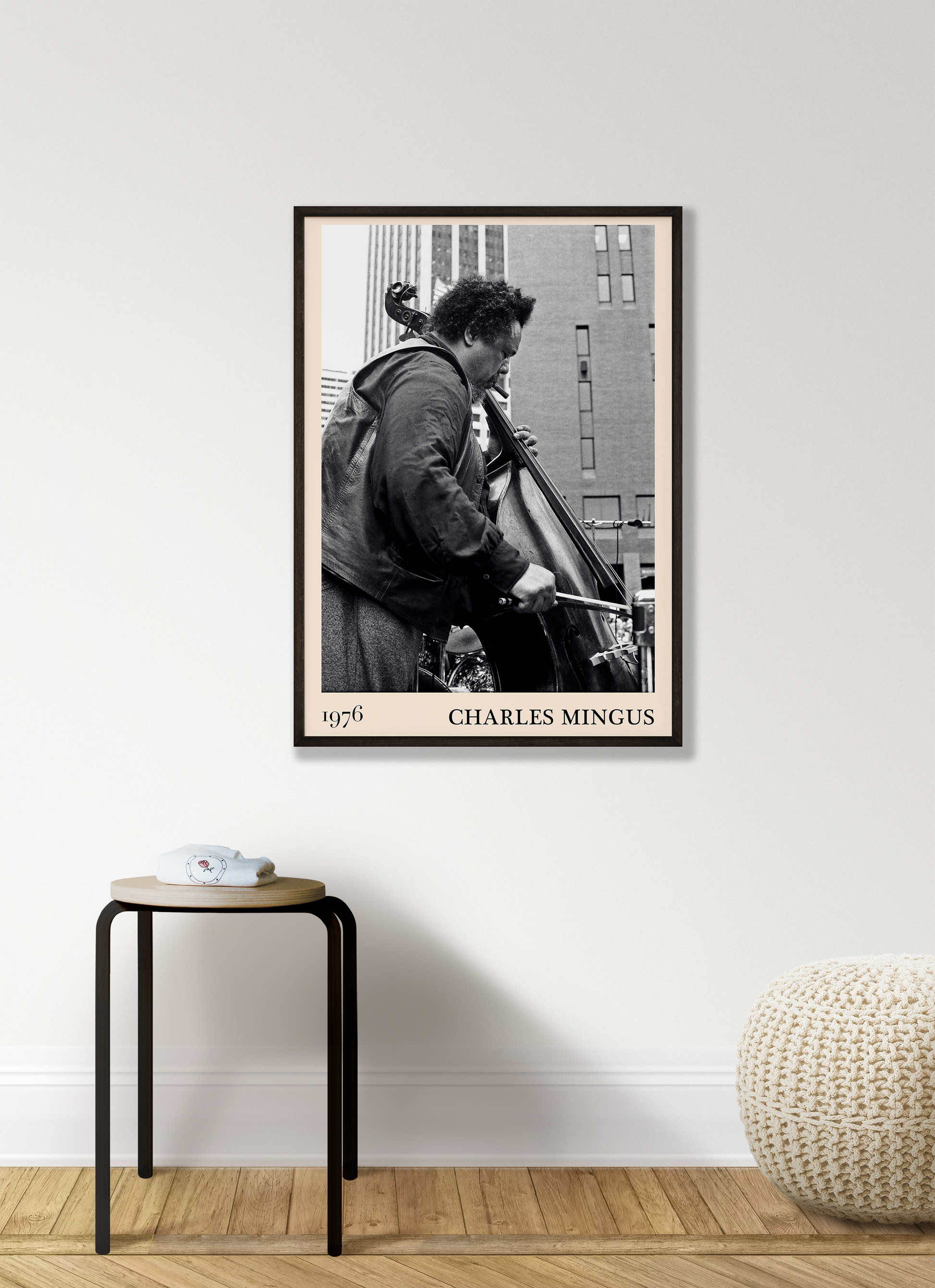 1976 photograph of Charles Mingus taken by Thomas Marcello. Picture crafted into a cool black framed music print, with an off-white border. Poster is hanging on a white living room wall.
